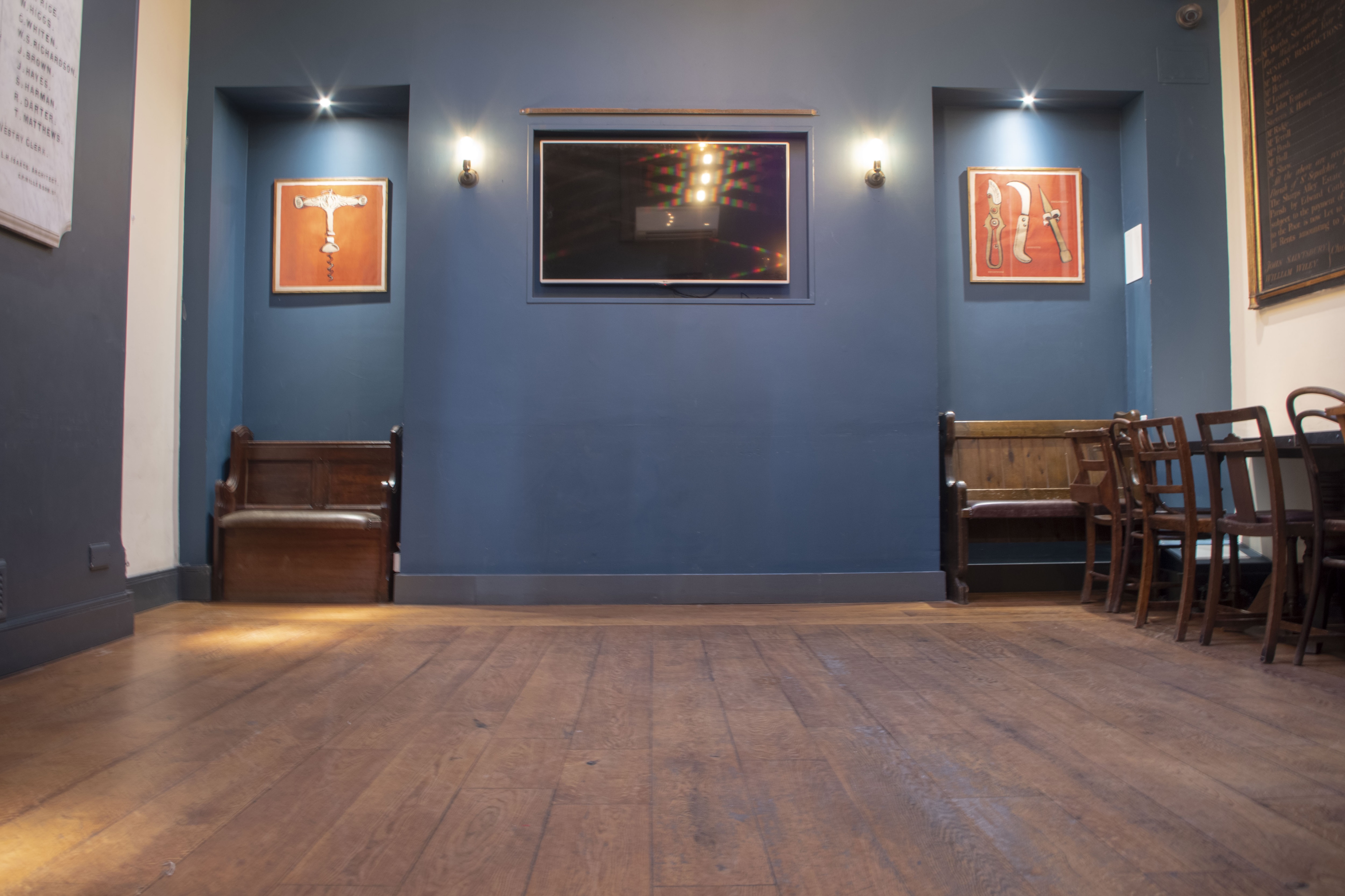 Modern event space with blue walls, ideal for meetings and gatherings.