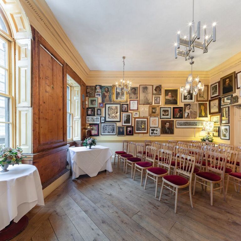 Dining room at The Union Club with eclectic art, perfect for workshops and gatherings.