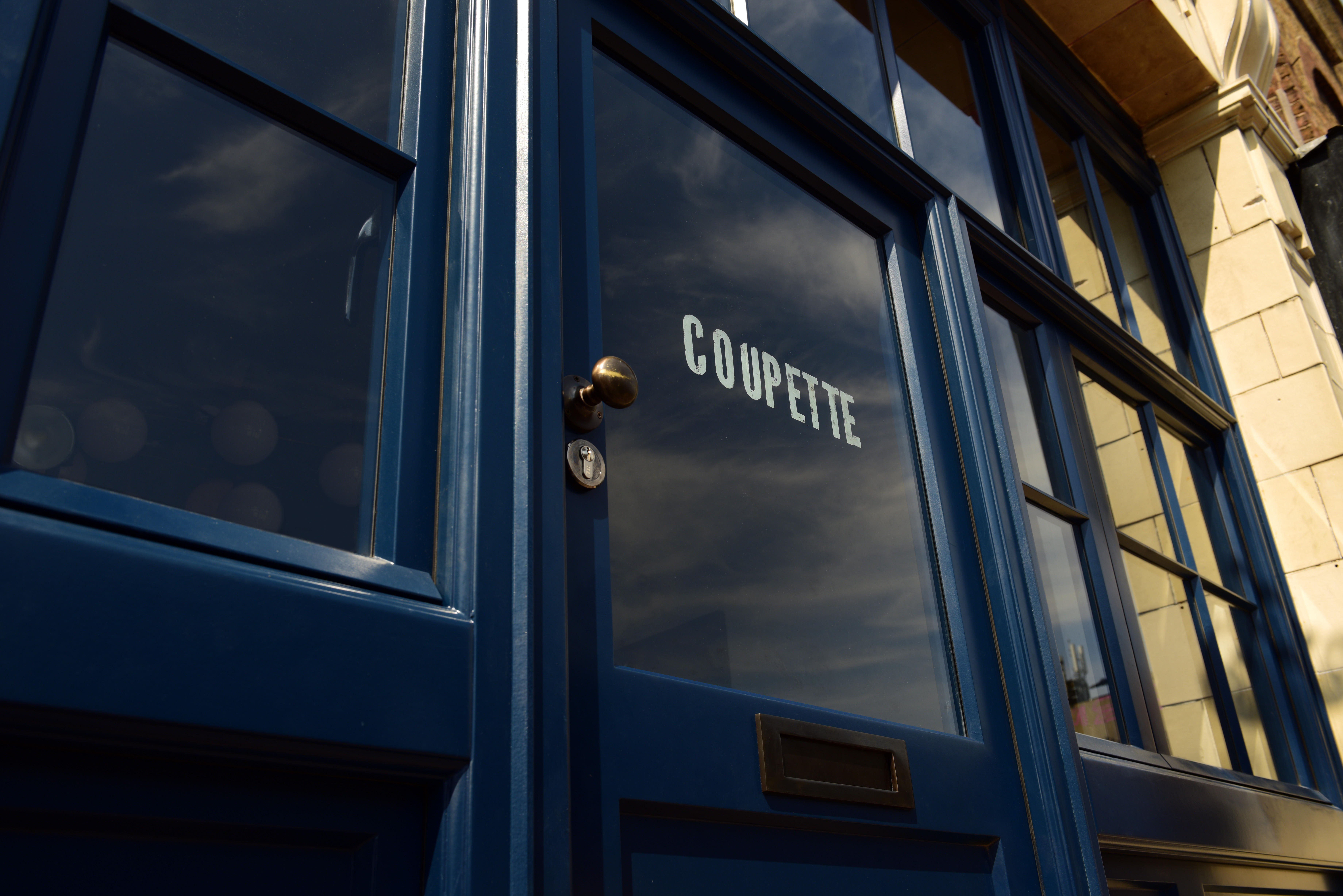 Stylish blue door entrance at Coupette, perfect for intimate gatherings and networking events.