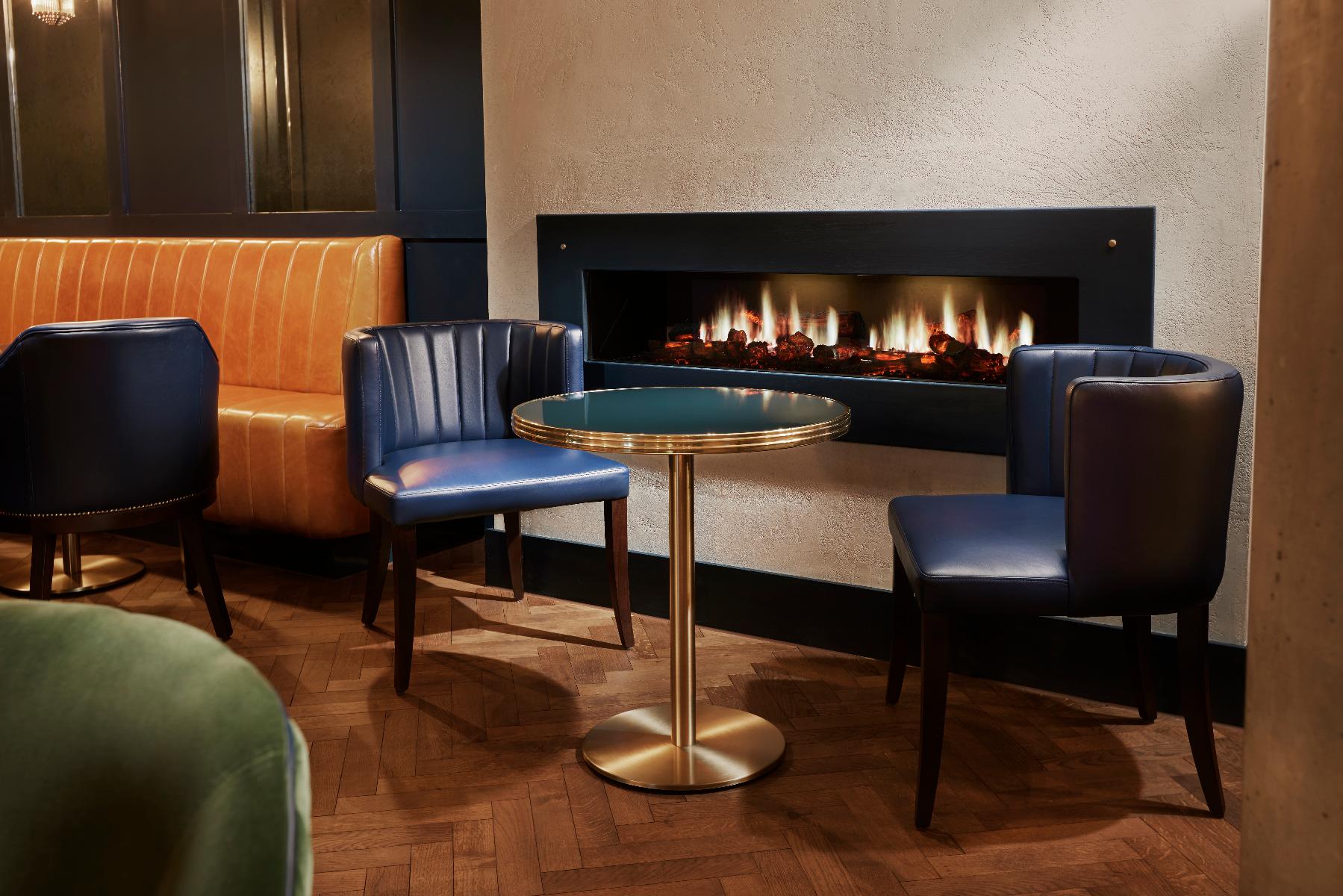 Cozy lounge at Marlin Waterloo, perfect for networking events with a warm fireplace.