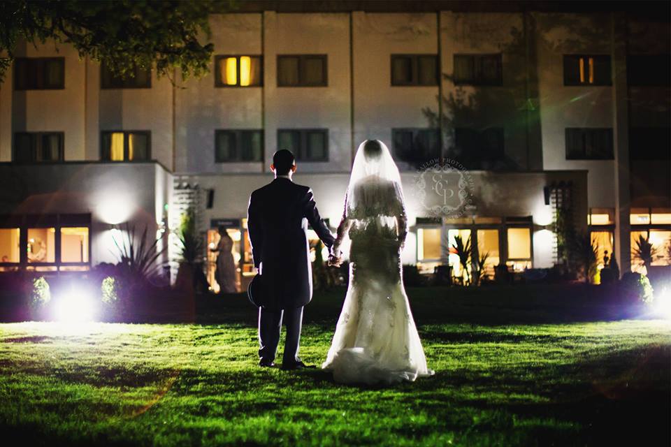 Couple holding hands in romantic Cheshire Suite, perfect for weddings and events.