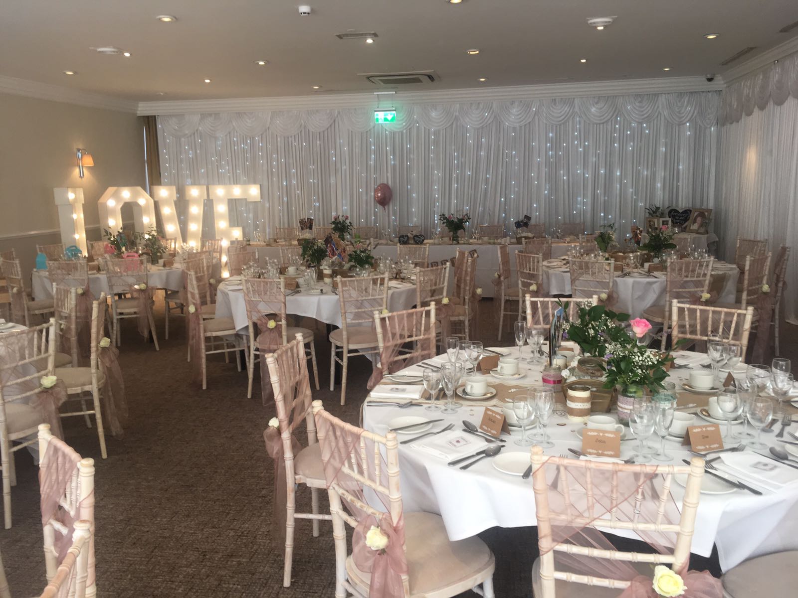 Cheshire Suite at Best Western Plus, elegant wedding venue with floral decor and "LOVE" sign.