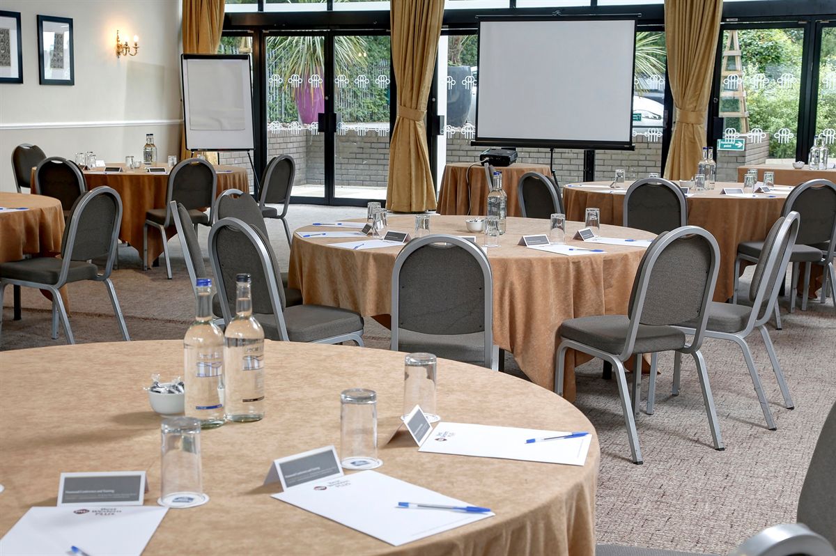 Cheshire Suite meeting space with round tables, ideal for conferences and events.