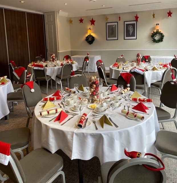 Cheshire Suite festive event setup with red and white decor for holiday gatherings.