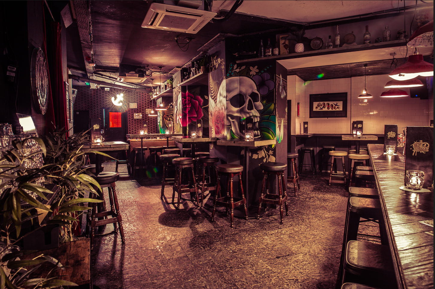 Stylish venue with skull mural, ideal for casual gatherings and themed events.