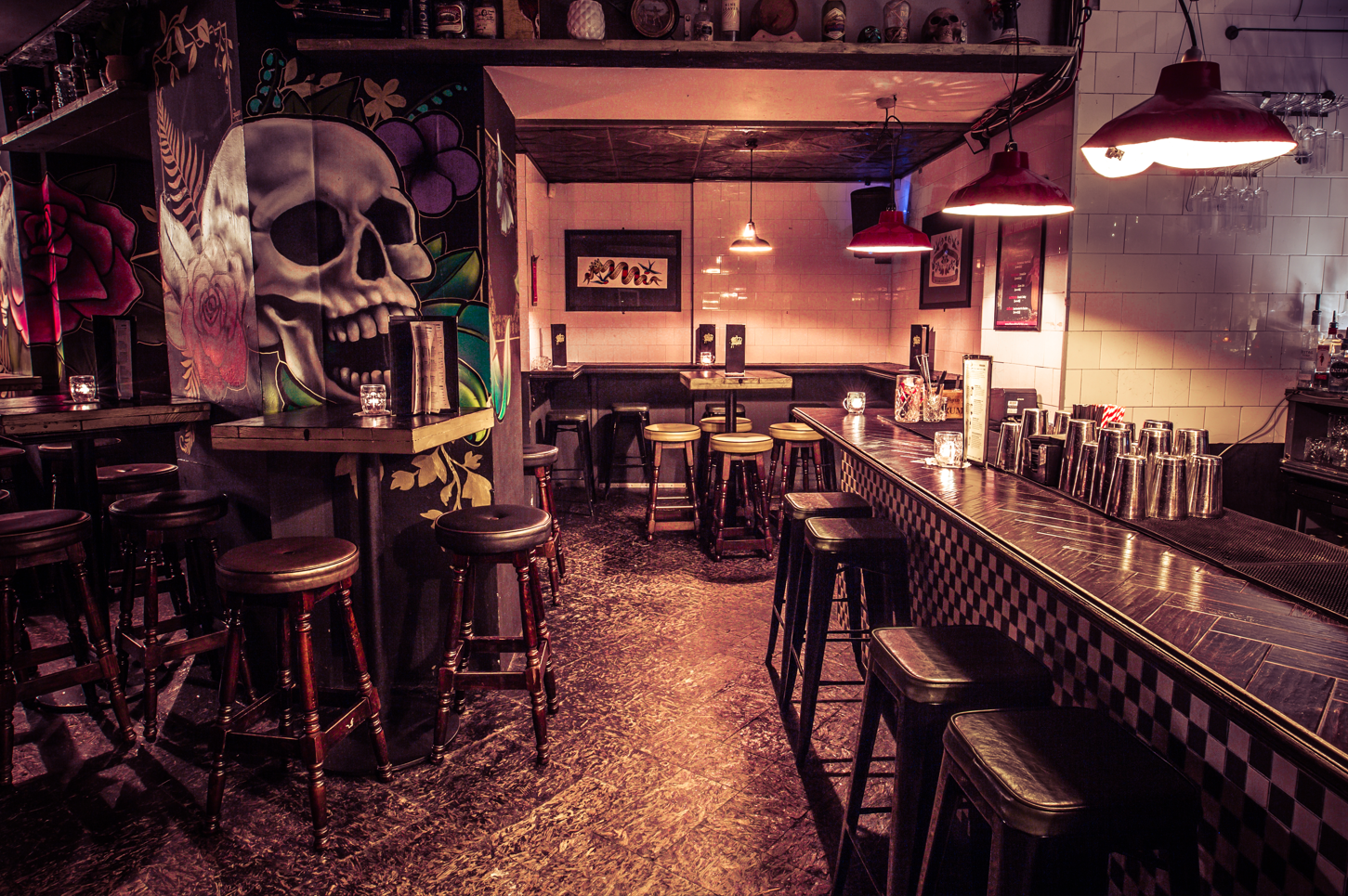 Vibrant Cocktail Club venue with skull mural, perfect for networking events and celebrations.