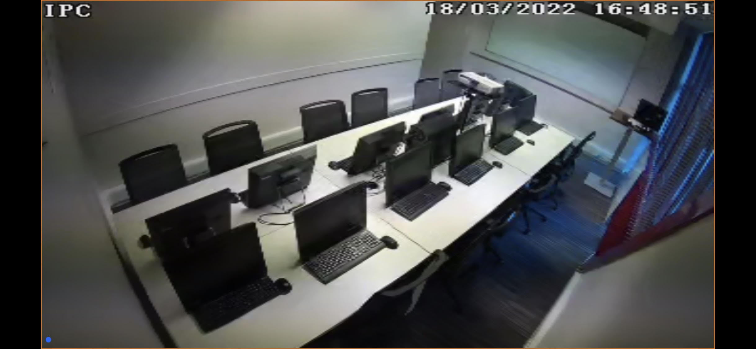 Modern meeting room with computer stations for hybrid training events.