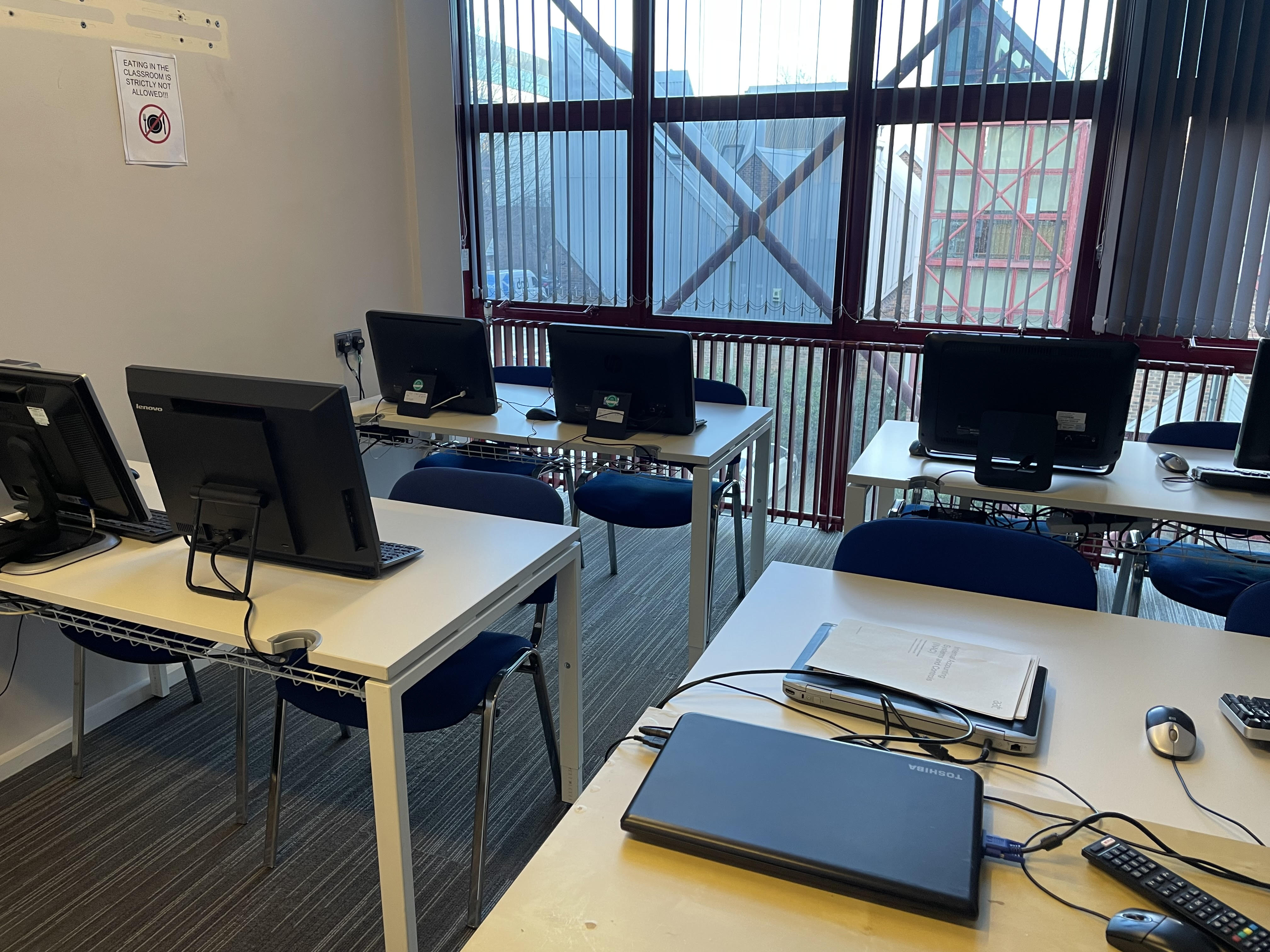 "Suite Avon meeting room with computer stations for tech training workshops"