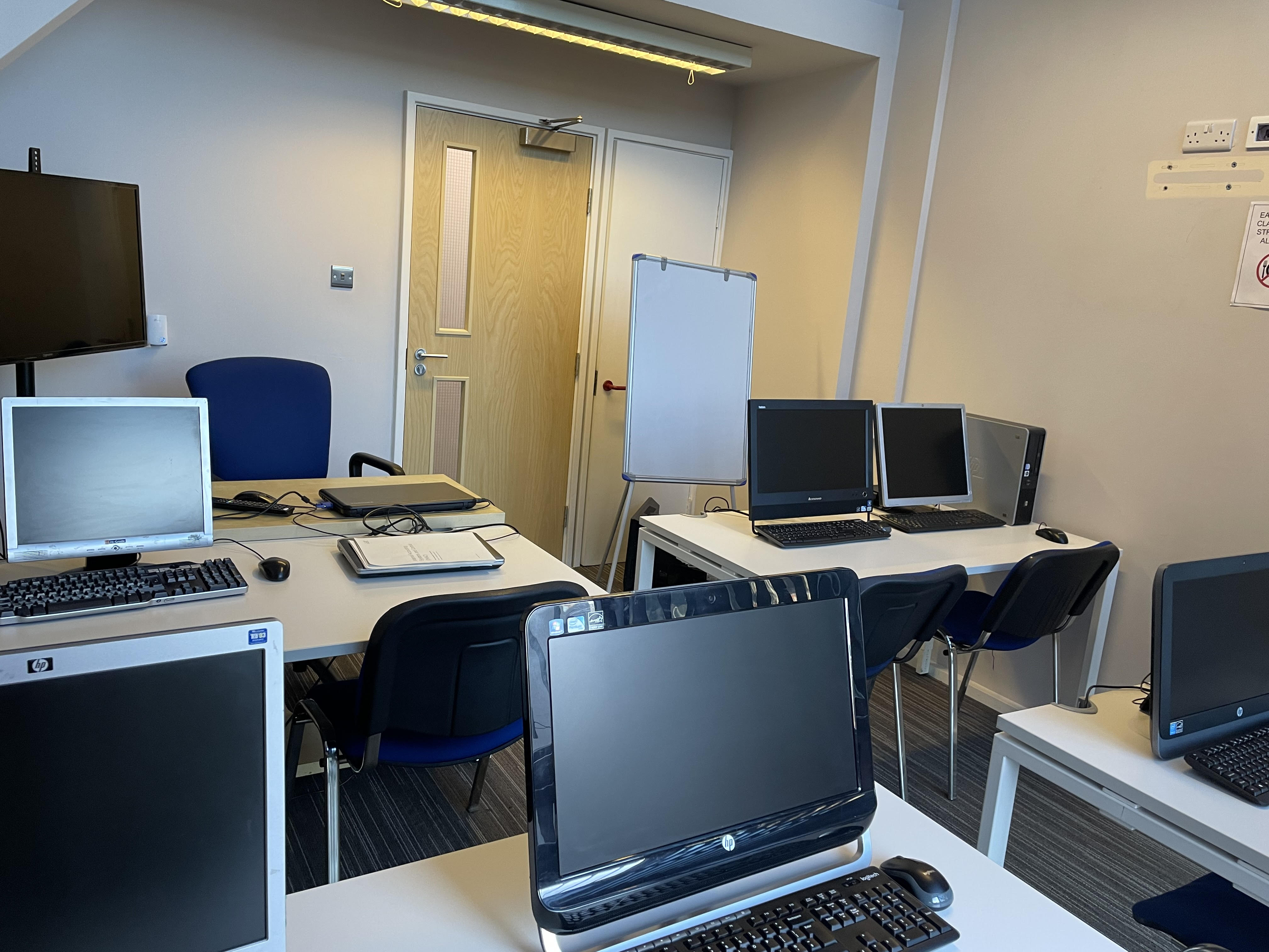 Functional meeting room with computer stations for training sessions and workshops.