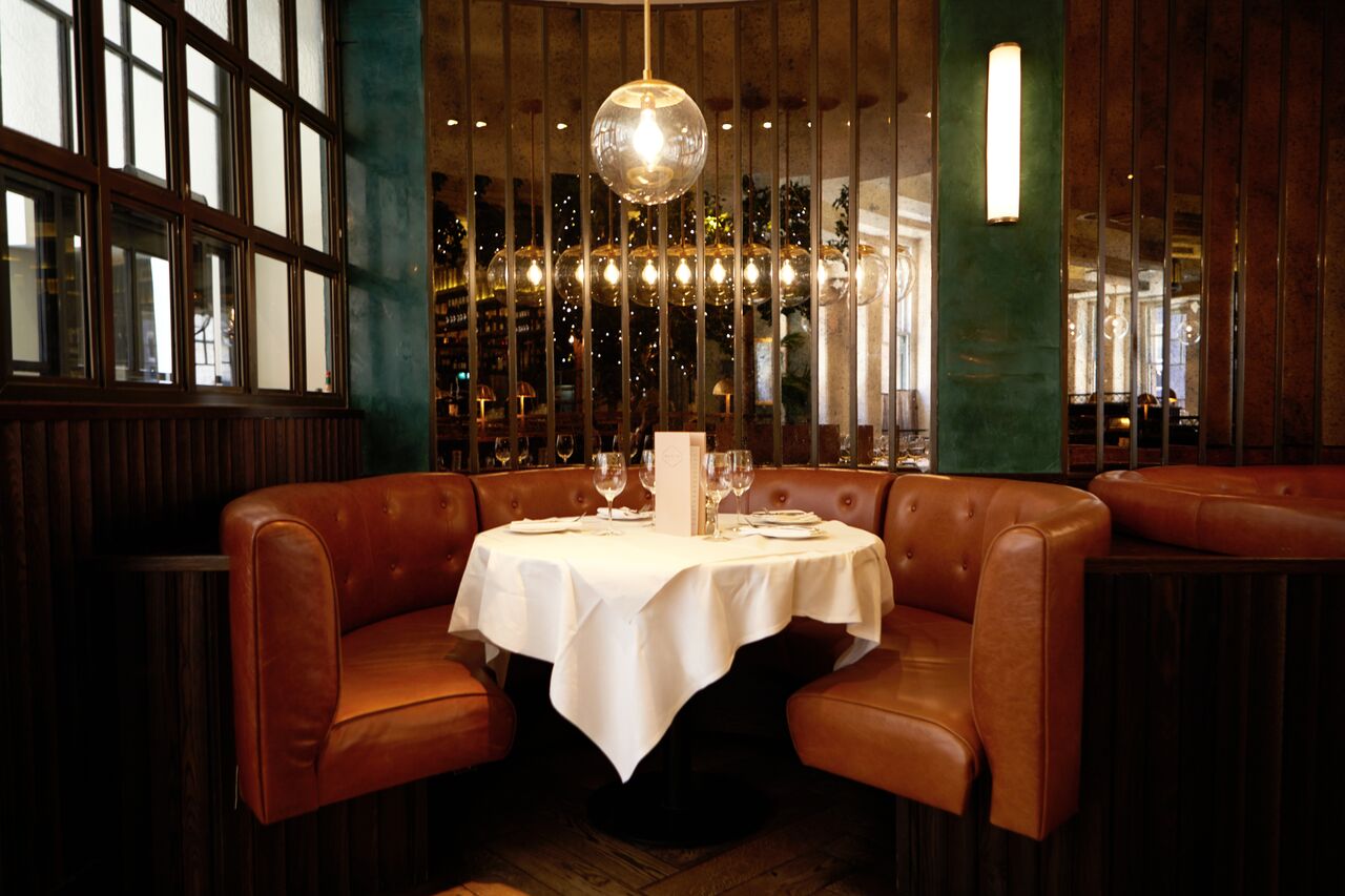 Intimate booth dining setup for private events at Gusto Restaurant, Manchester.