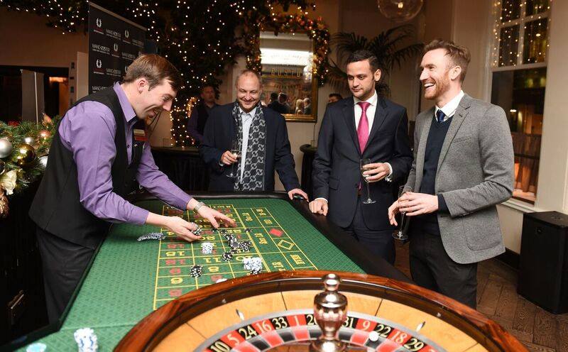 Casino-themed event at Gusto Restaurant Manchester with roulette table for networking.