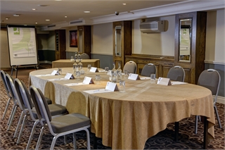 Tatton Suite meeting room with round table, ideal for professional gatherings and events.