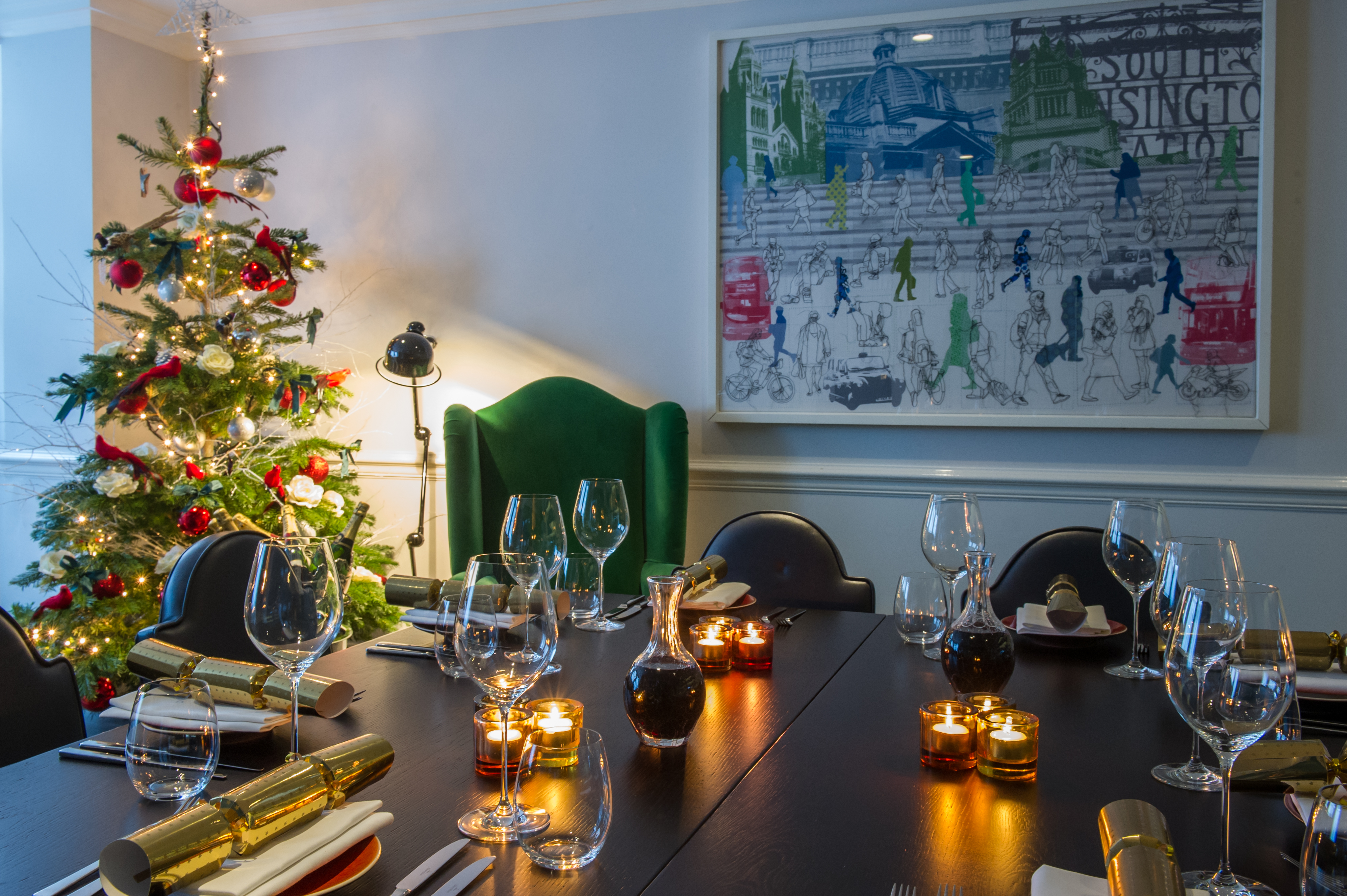 Elegant dining table with glassware, Christmas tree for holiday gatherings at The Ampersand Hotel.