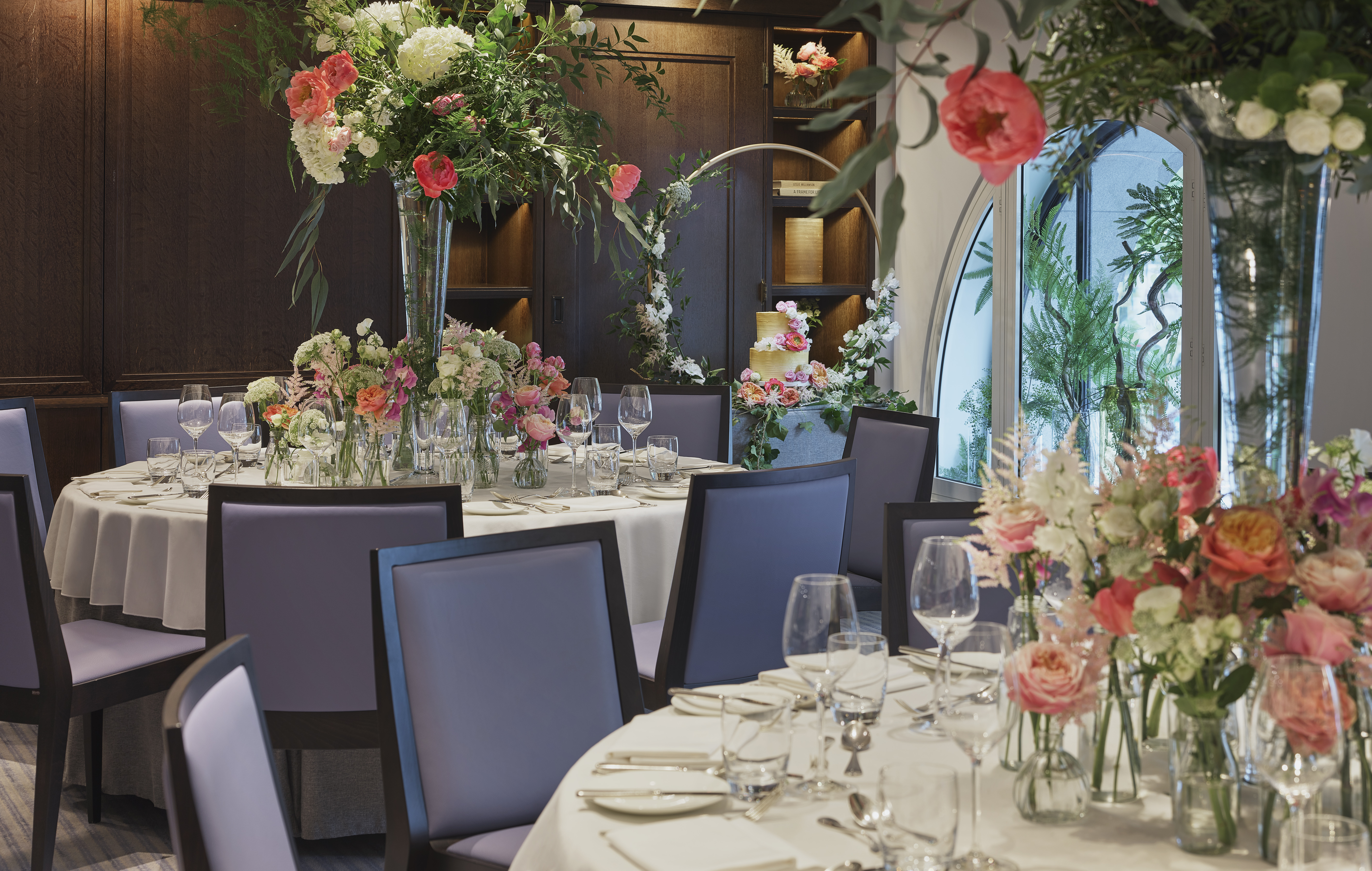 Elegant dining table with floral arrangements in The Press Room, One Aldwych event space.