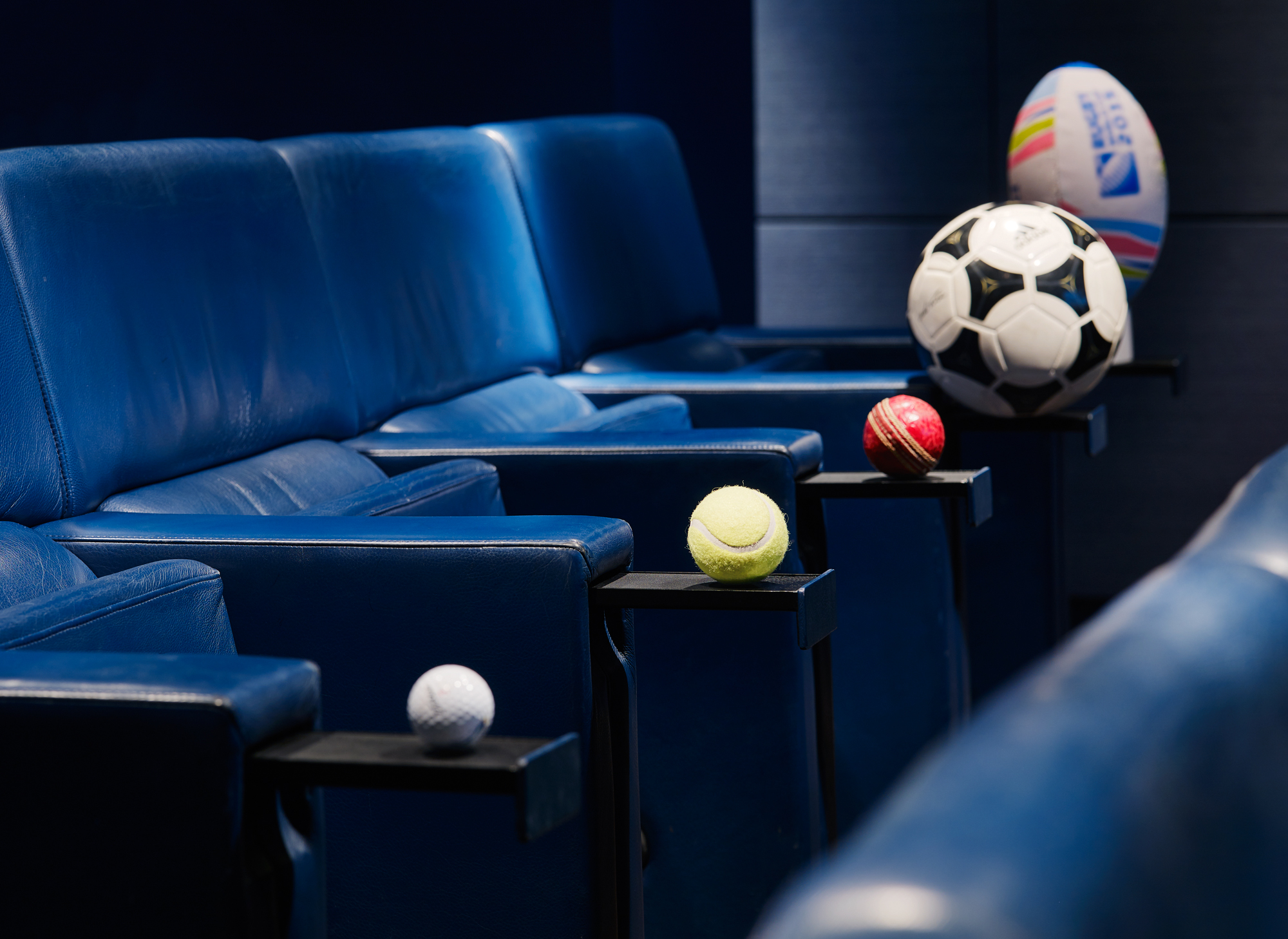 Sports-themed event seating with blue chairs and cup holders at The Screening Room, One Aldwych.