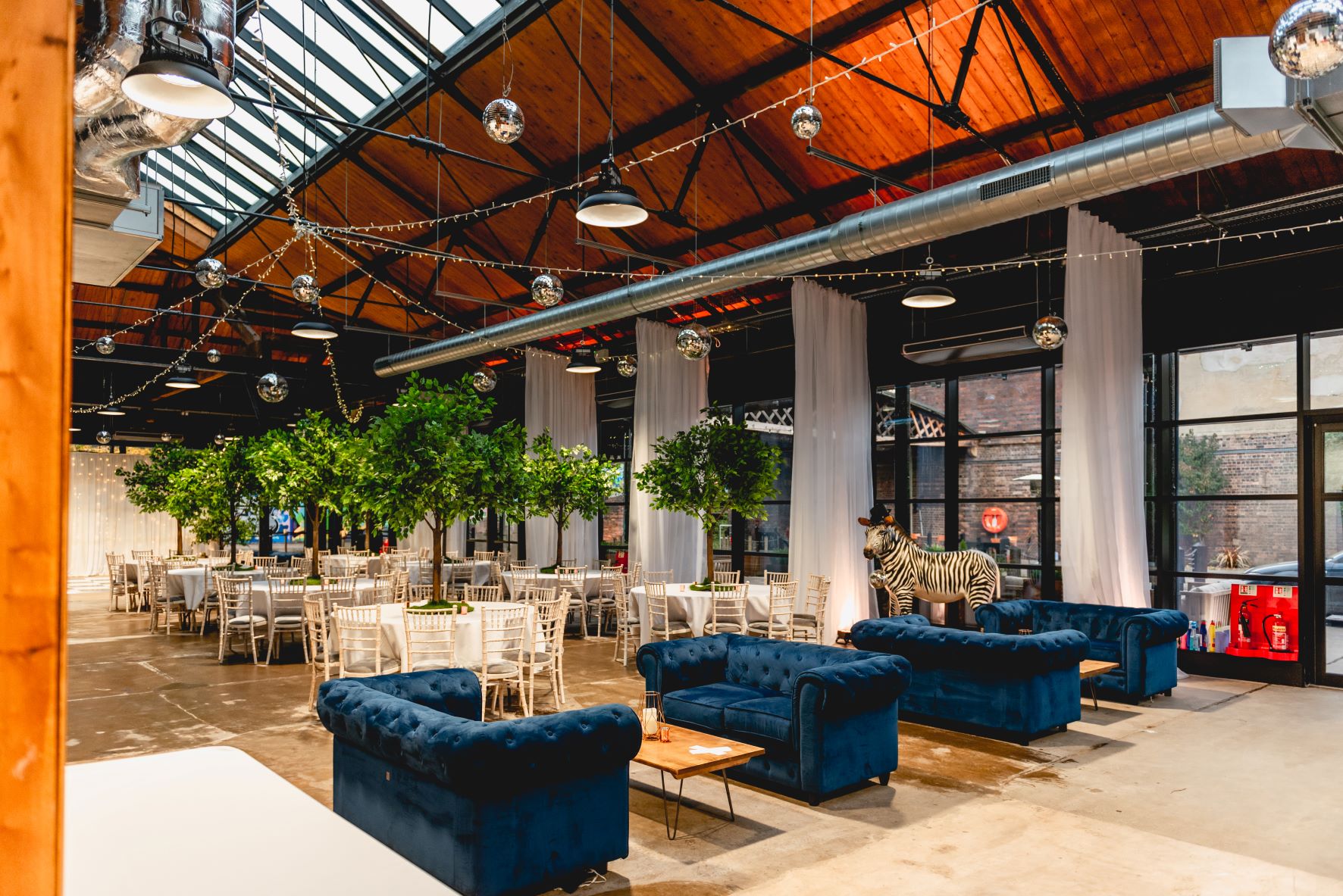 Wedding venue with high ceilings, ideal for celebrations and networking events.