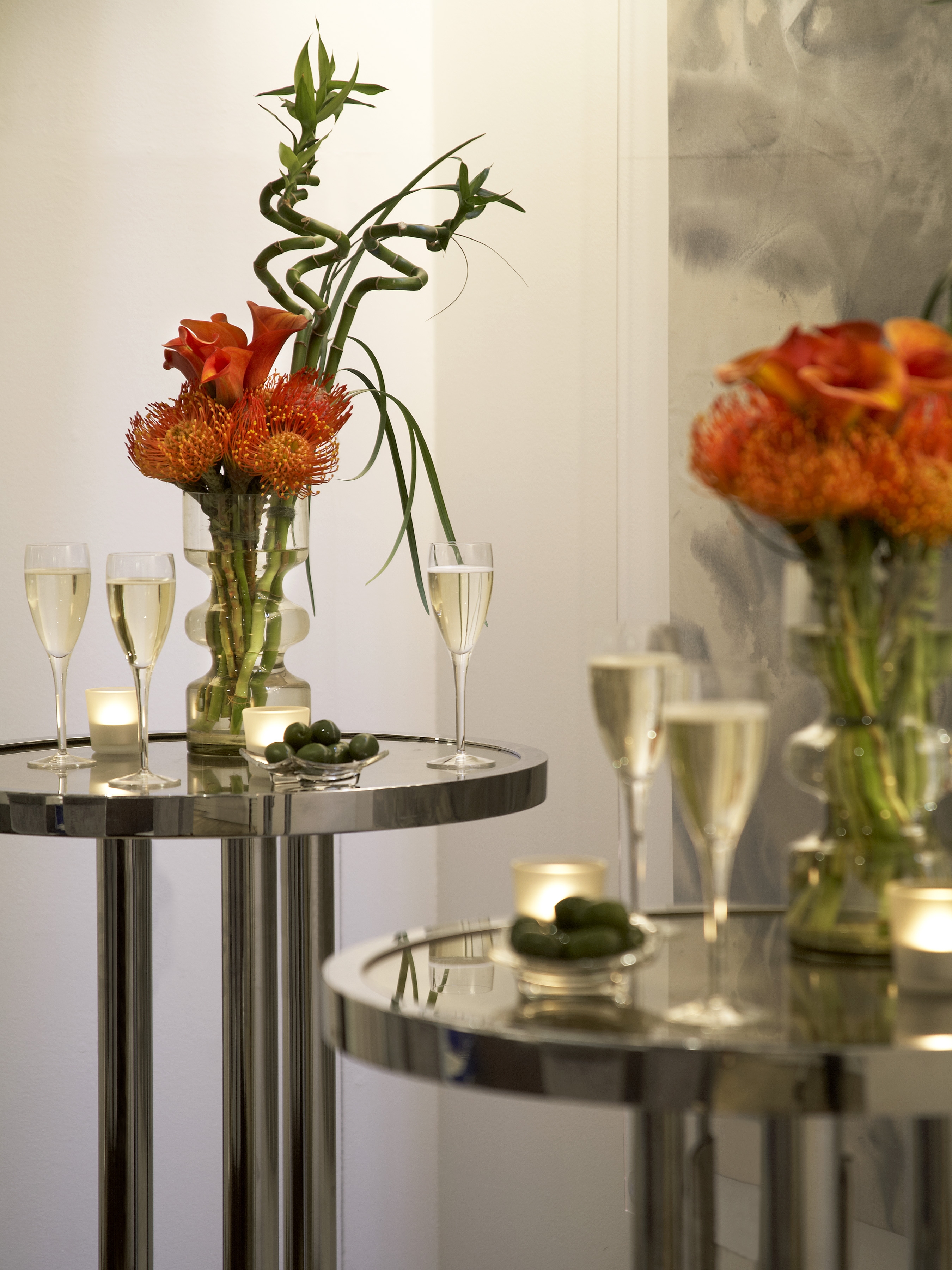 Elegant event space at The Print Room, One Aldwych, with floral centerpieces and soft lighting.