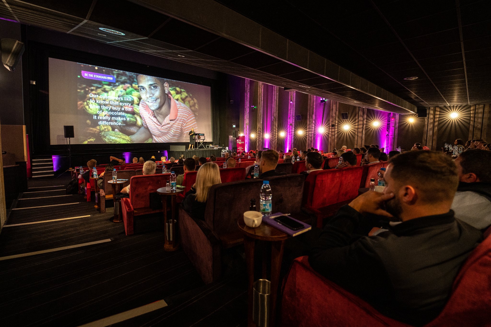 Engaging speaker on screen at Everyman Leeds event in cozy cinema setting.