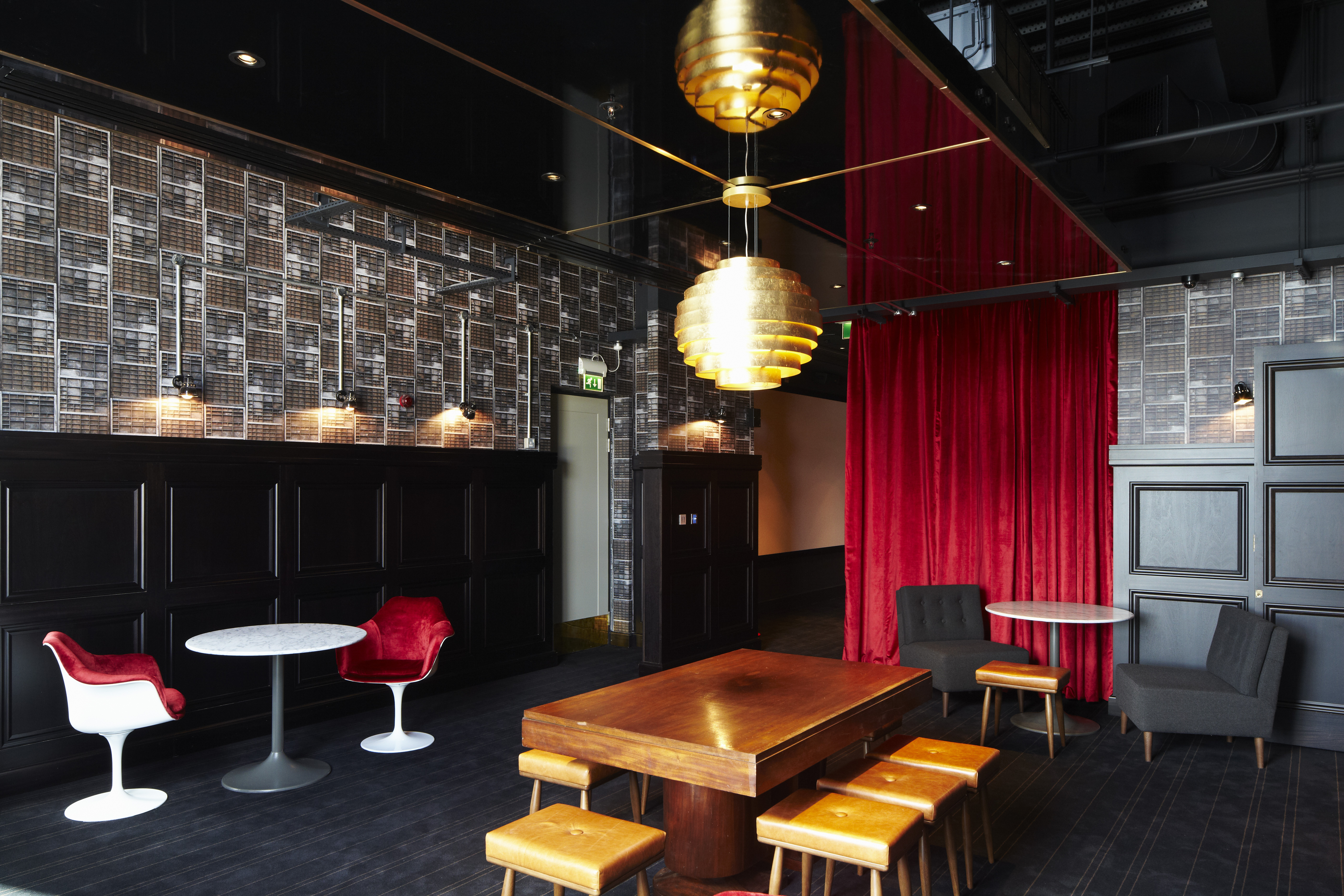 Stylish event space in Everyman Leeds with gold pendant lighting for upscale gatherings.