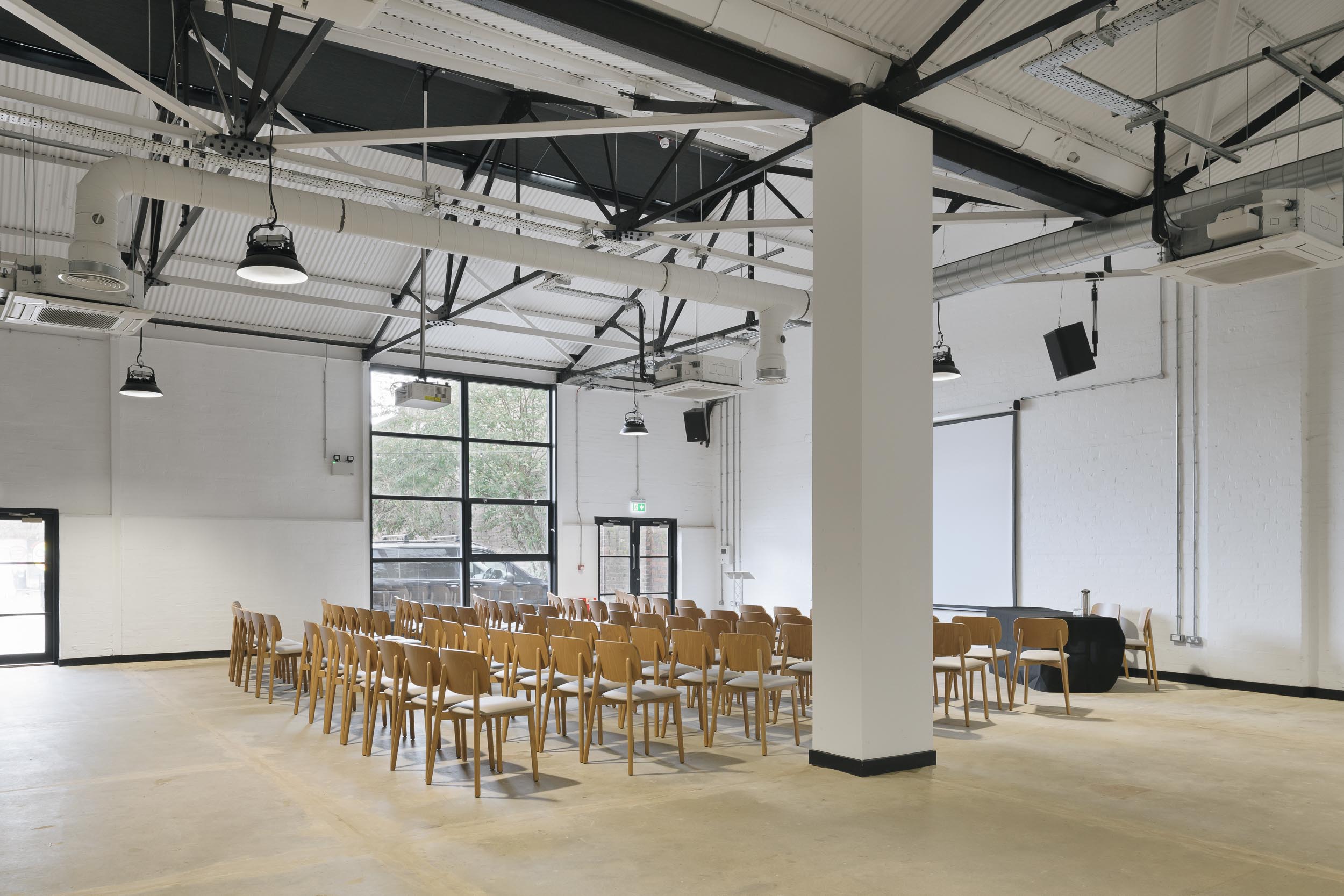 Versatile event space at Gatehouse, featuring high ceilings for corporate meetings and workshops.