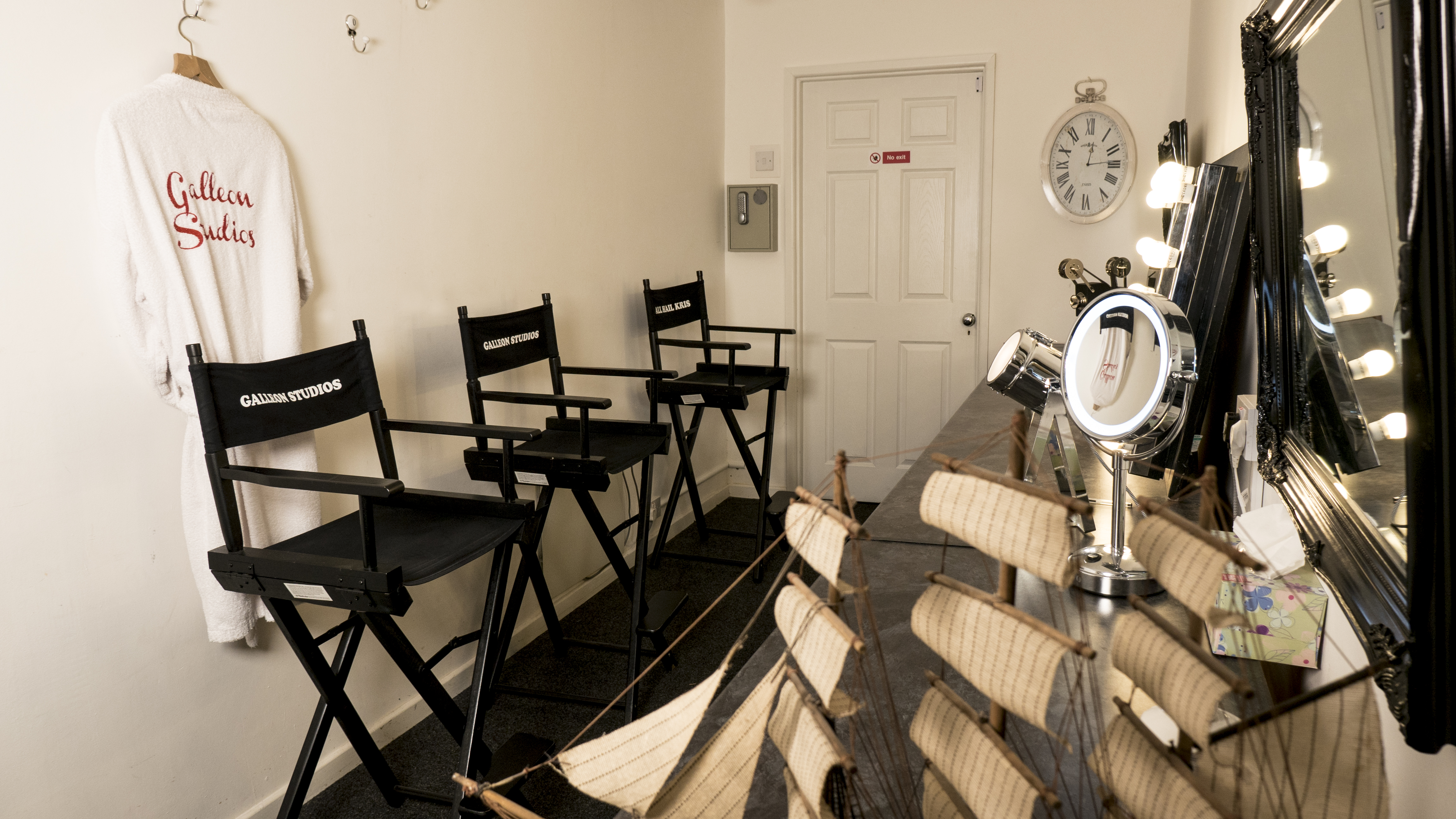 Infinity Cove dressing room with bright vanity lights for pre-event preparations.