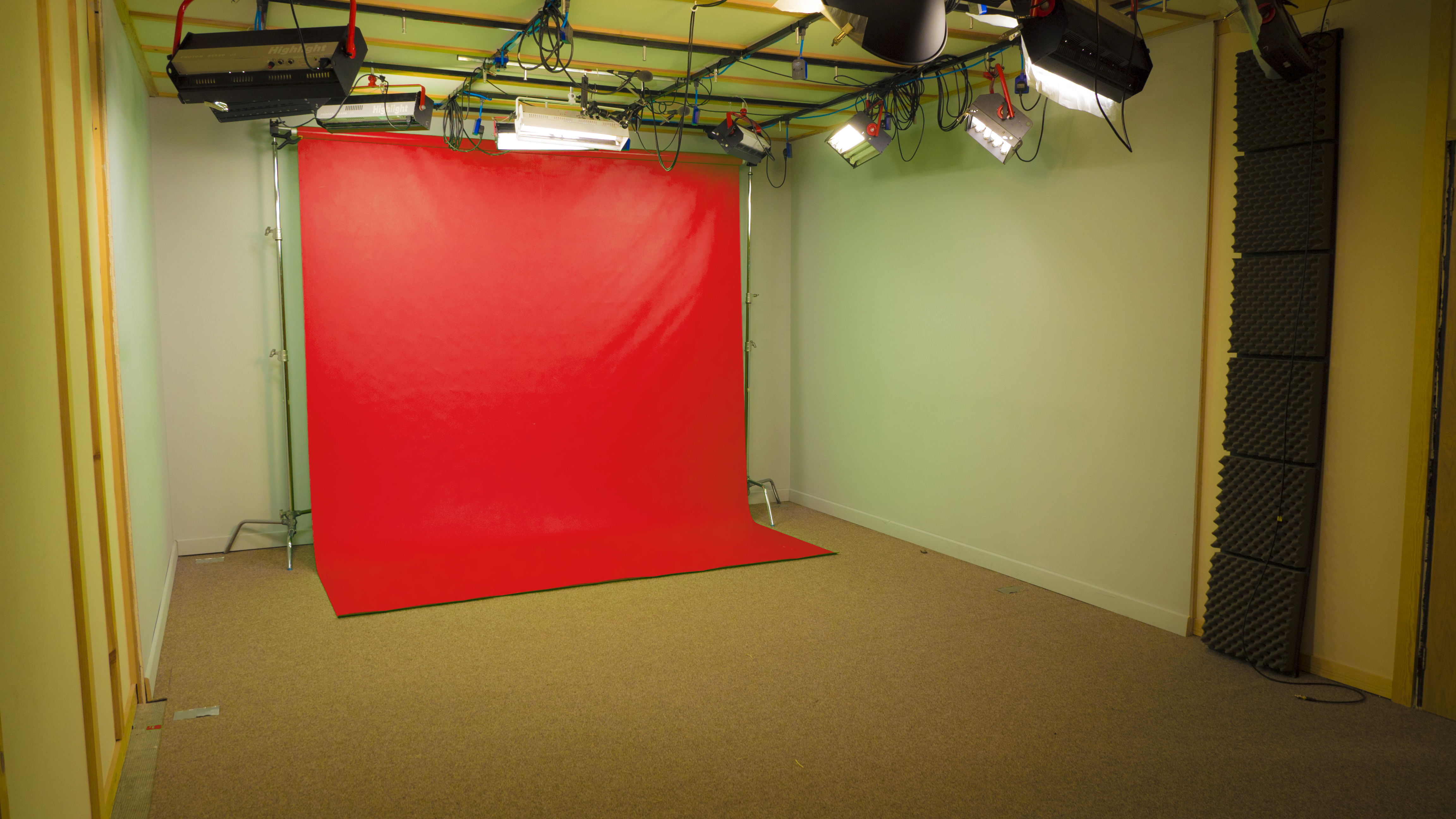 Soundproof Studio at Galleon Studios with red backdrop for events and presentations.