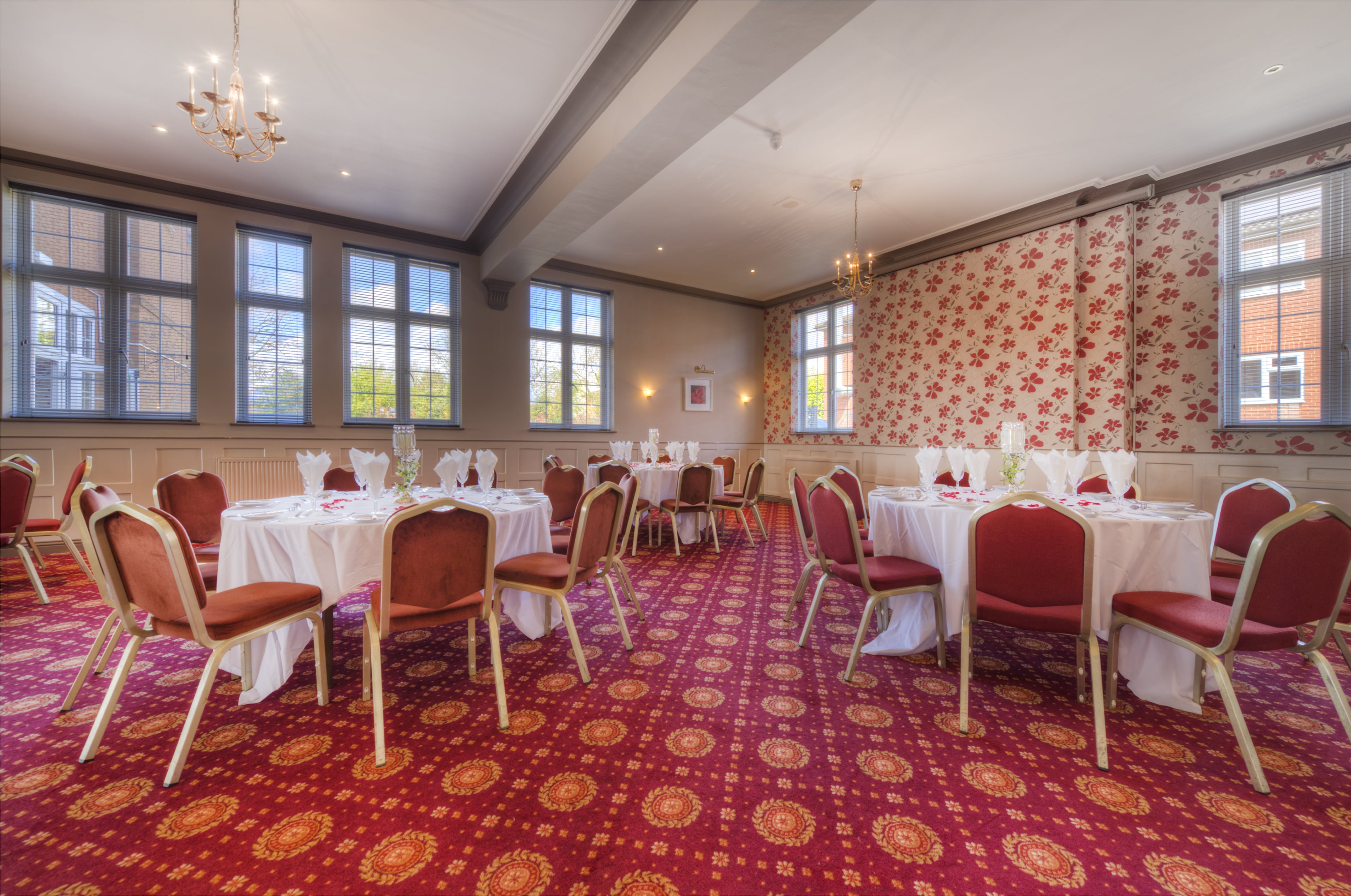 Manor Suite at Quality Hotel Coventry, elegant event space with round tables and natural light.