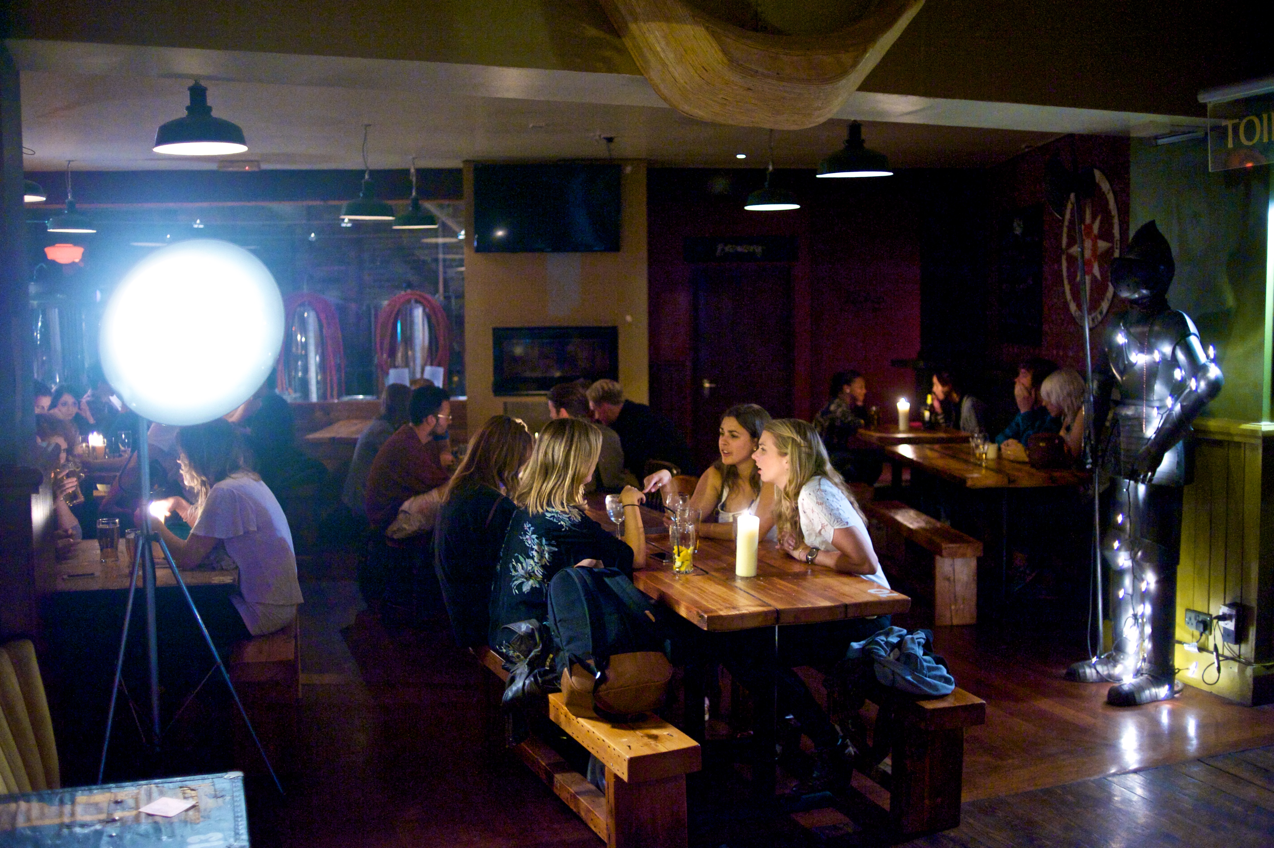 Cozy microbrewery venue with warm lighting, perfect for social mixers and gatherings.