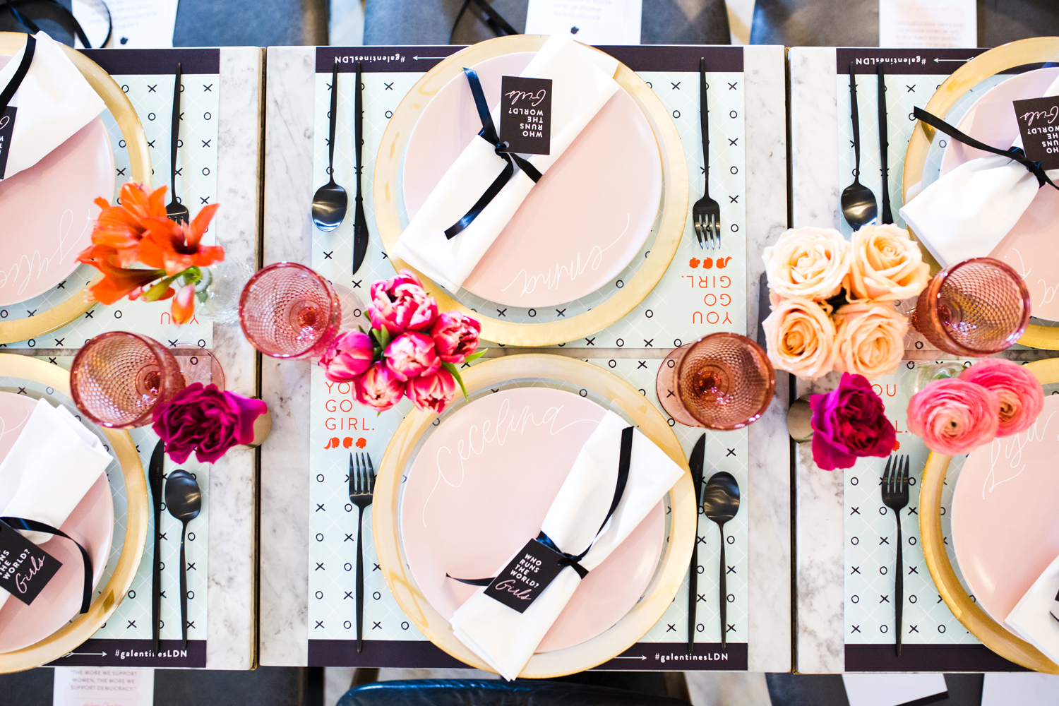 Elegant table setting at Café Duke, featuring pink plates and floral centerpieces for upscale events.