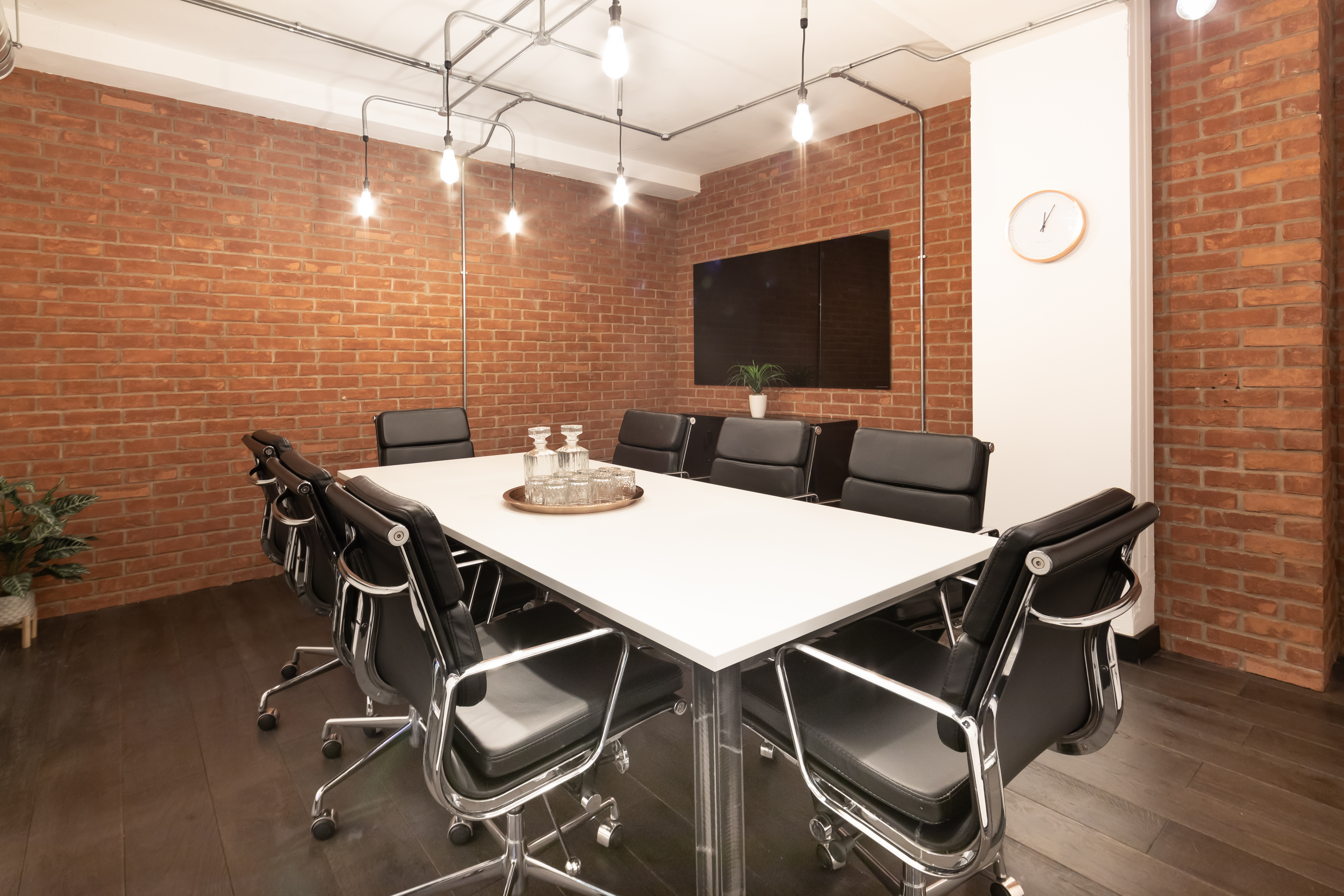 Modern meeting room with sleek table and ergonomic chairs, perfect for client pitches.