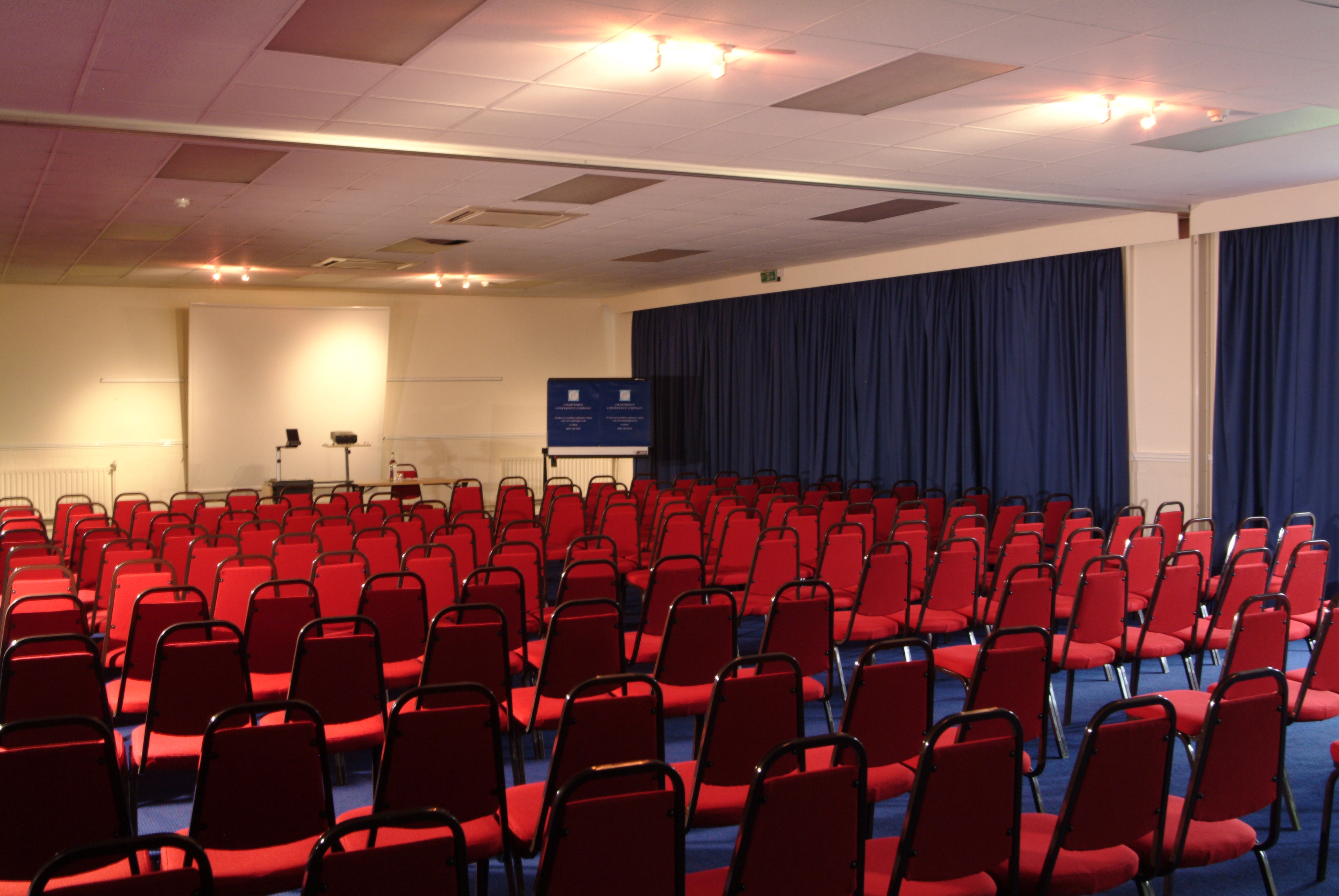Oak & Cedar Suite with red chairs, ideal for conferences and seminars.