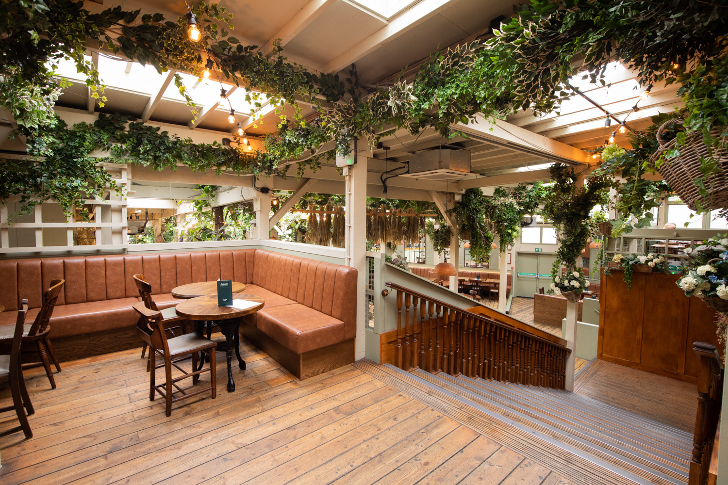 Elegant event space with greenery, perfect for gatherings and intimate dinners.