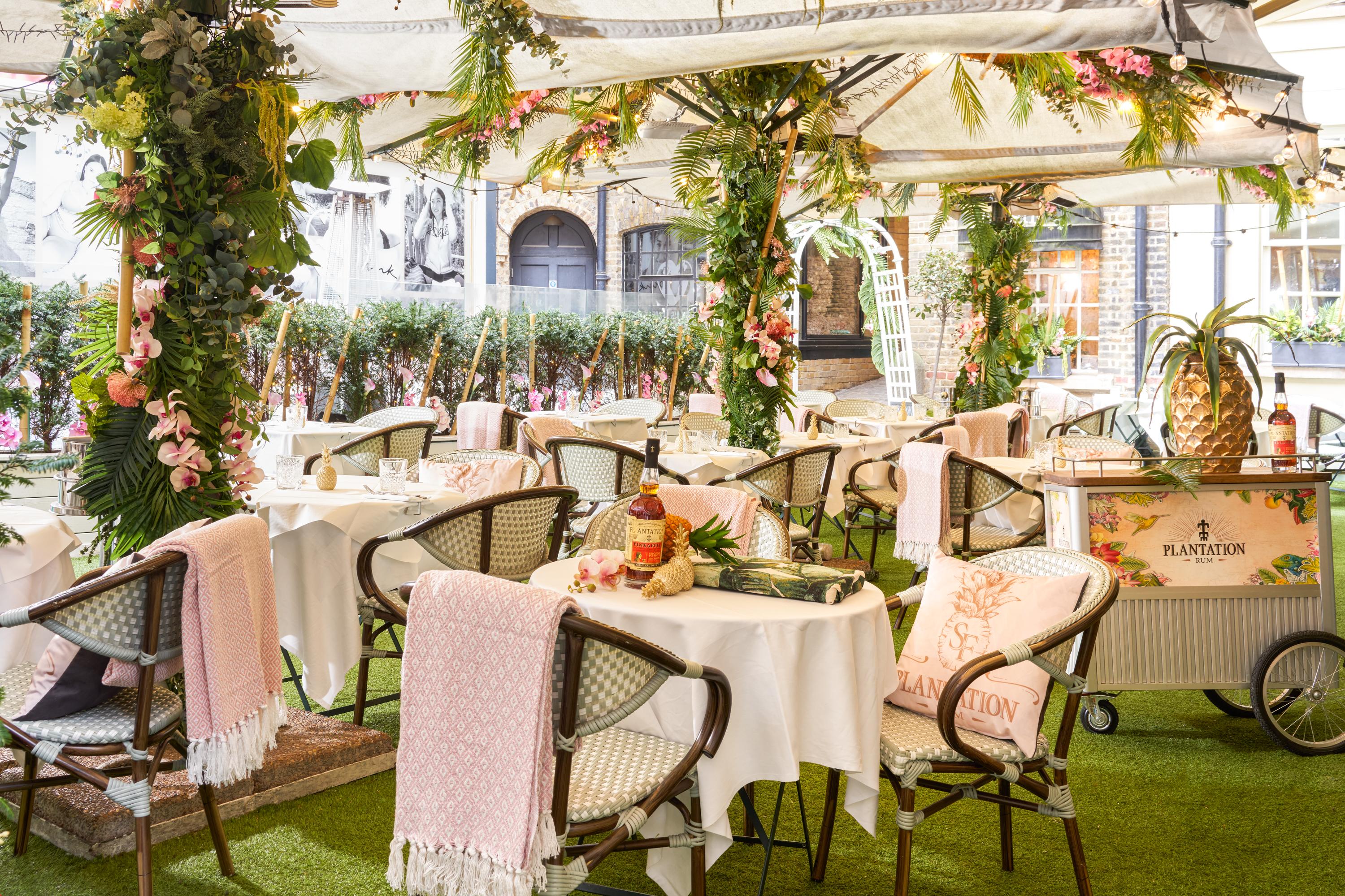 Elegant outdoor event space at Hush Mayfair with chic furnishings and lush greenery.