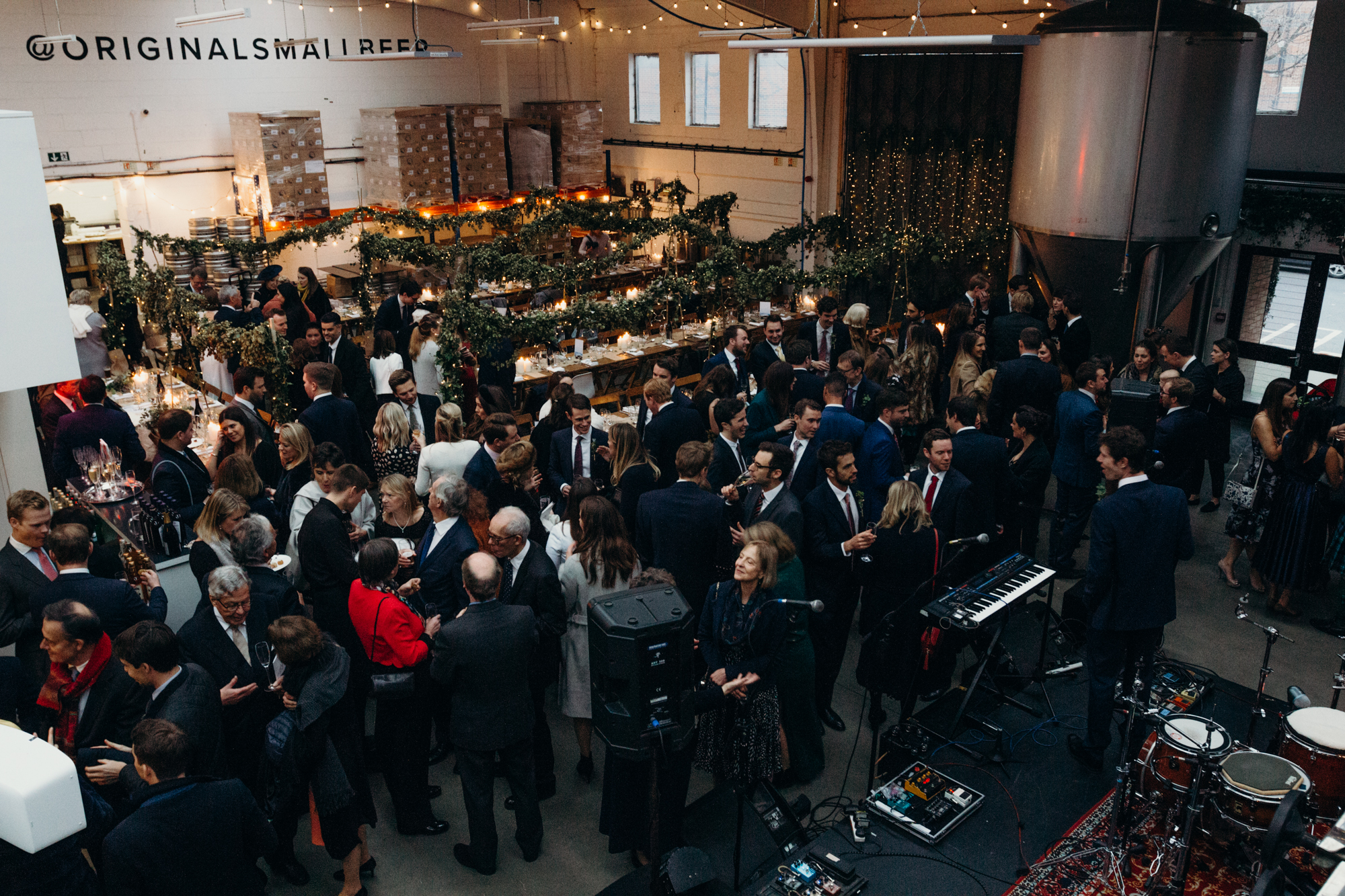 Networking event at Small Beer Brewery's Main Brew Room with elegant decor and live music.