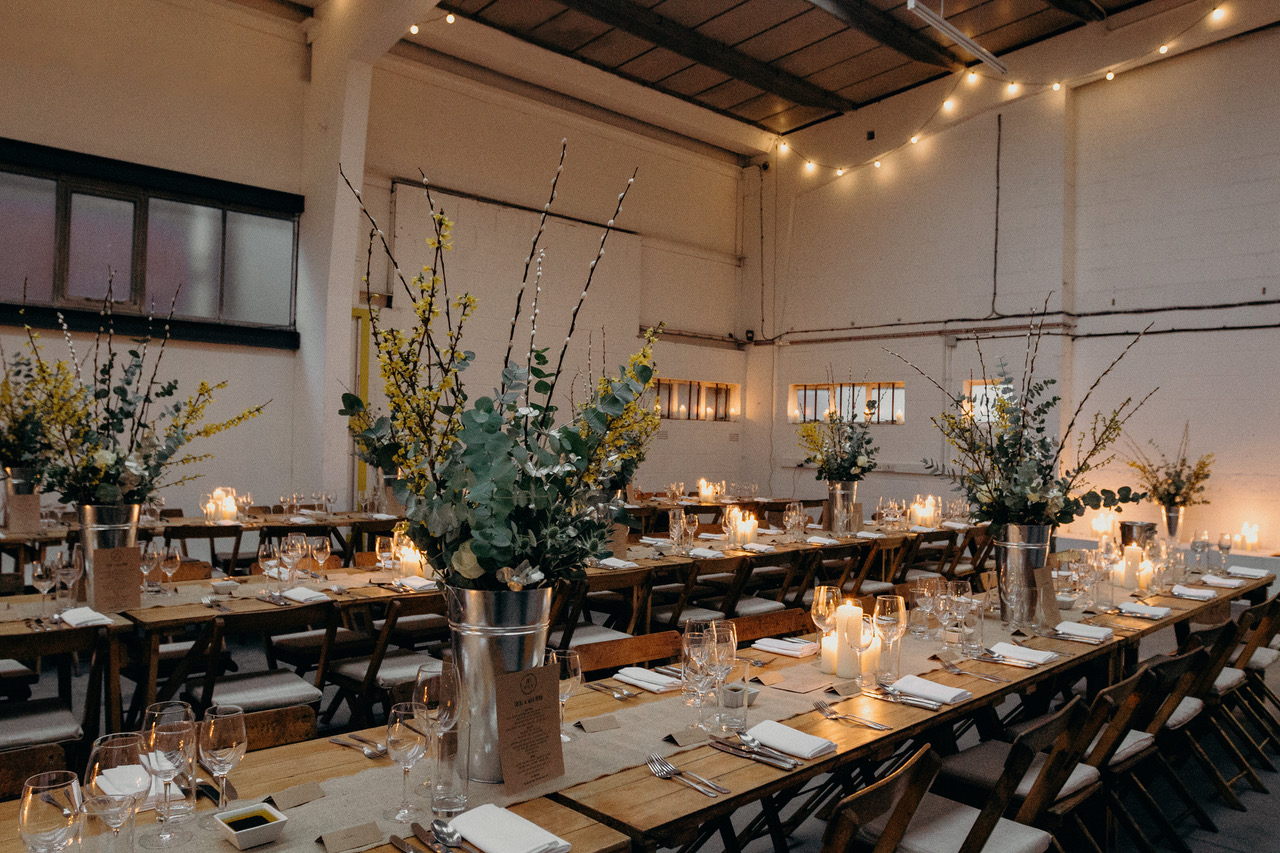 Elegant event space with long tables, ideal for sophisticated dinners and gatherings.