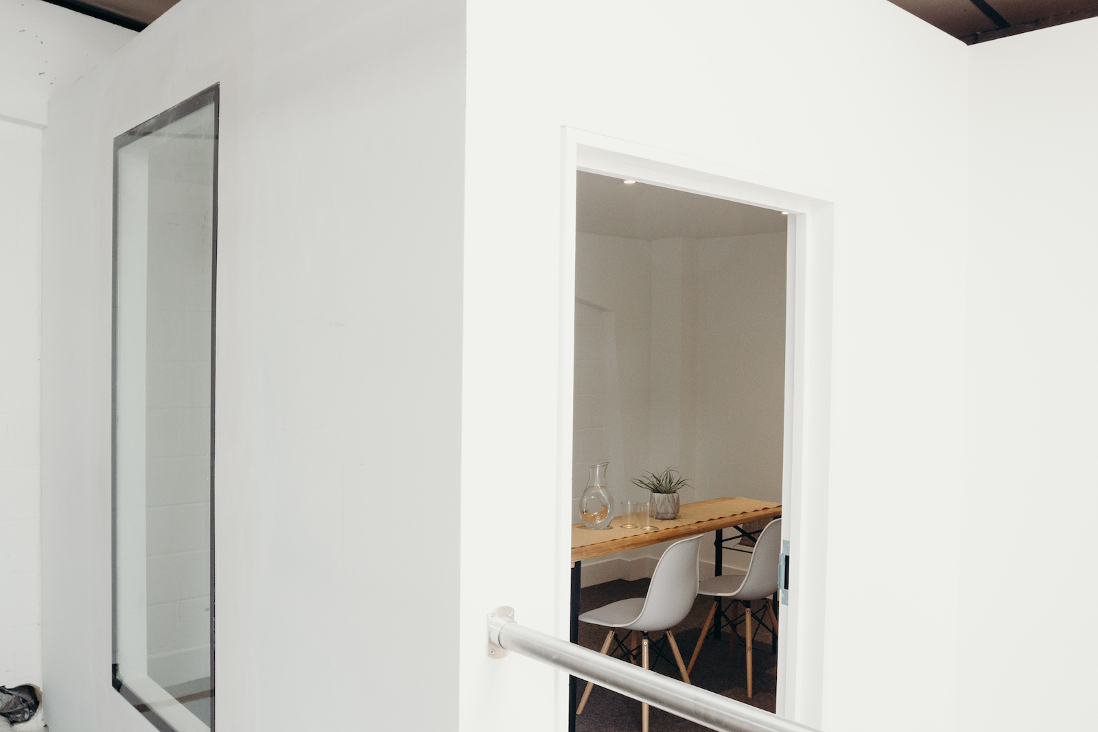 Modern meeting room with glass walls at Small Beer Brewery for team brainstorming sessions.