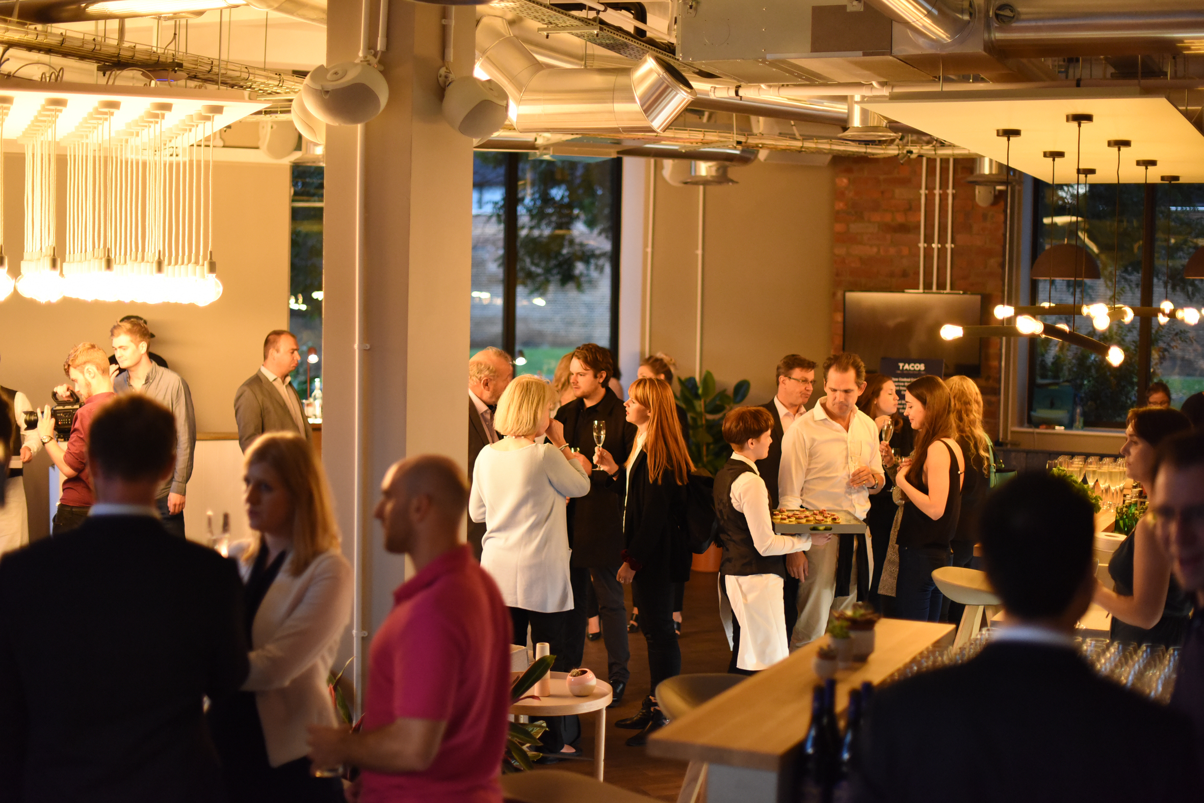 Vibrant networking event at Cafe Lounge in Uncommon Borough with elegant lighting.