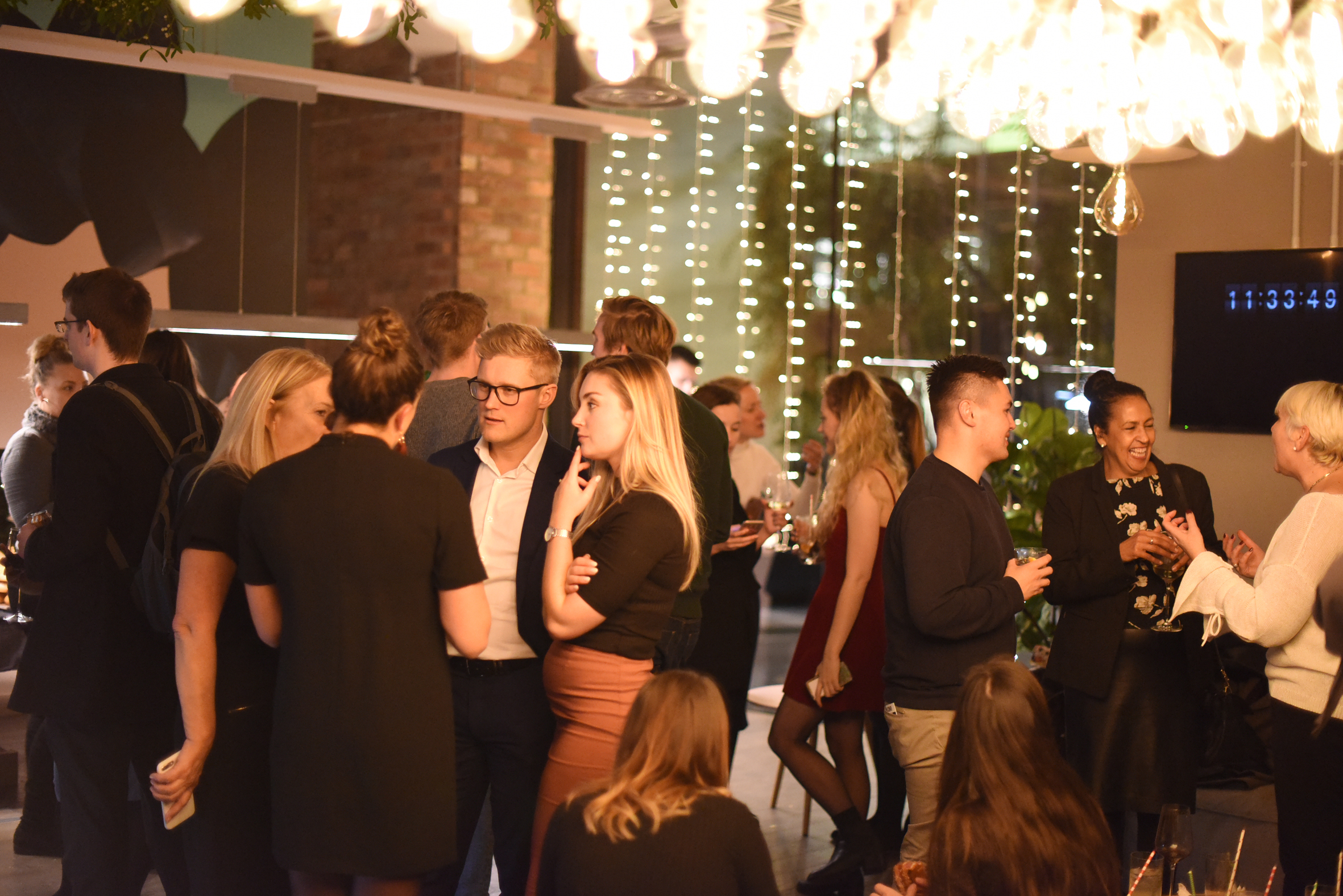 Vibrant networking event at Cafe Lounge, Uncommon Borough with modern decor and warm lighting.