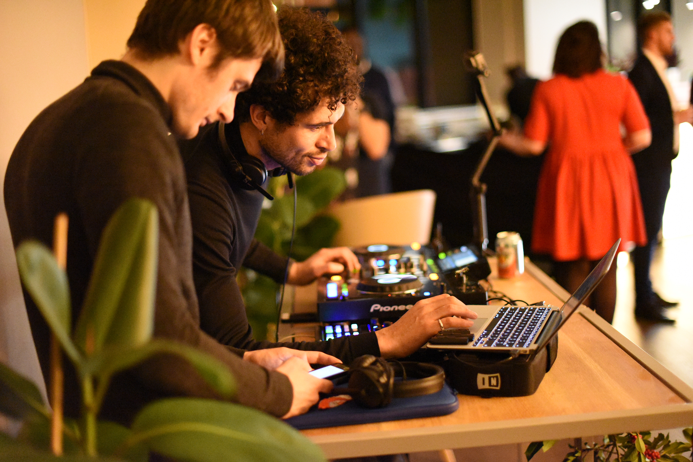 DJs collaborating at Cafe Lounge event, showcasing live entertainment and sound management.