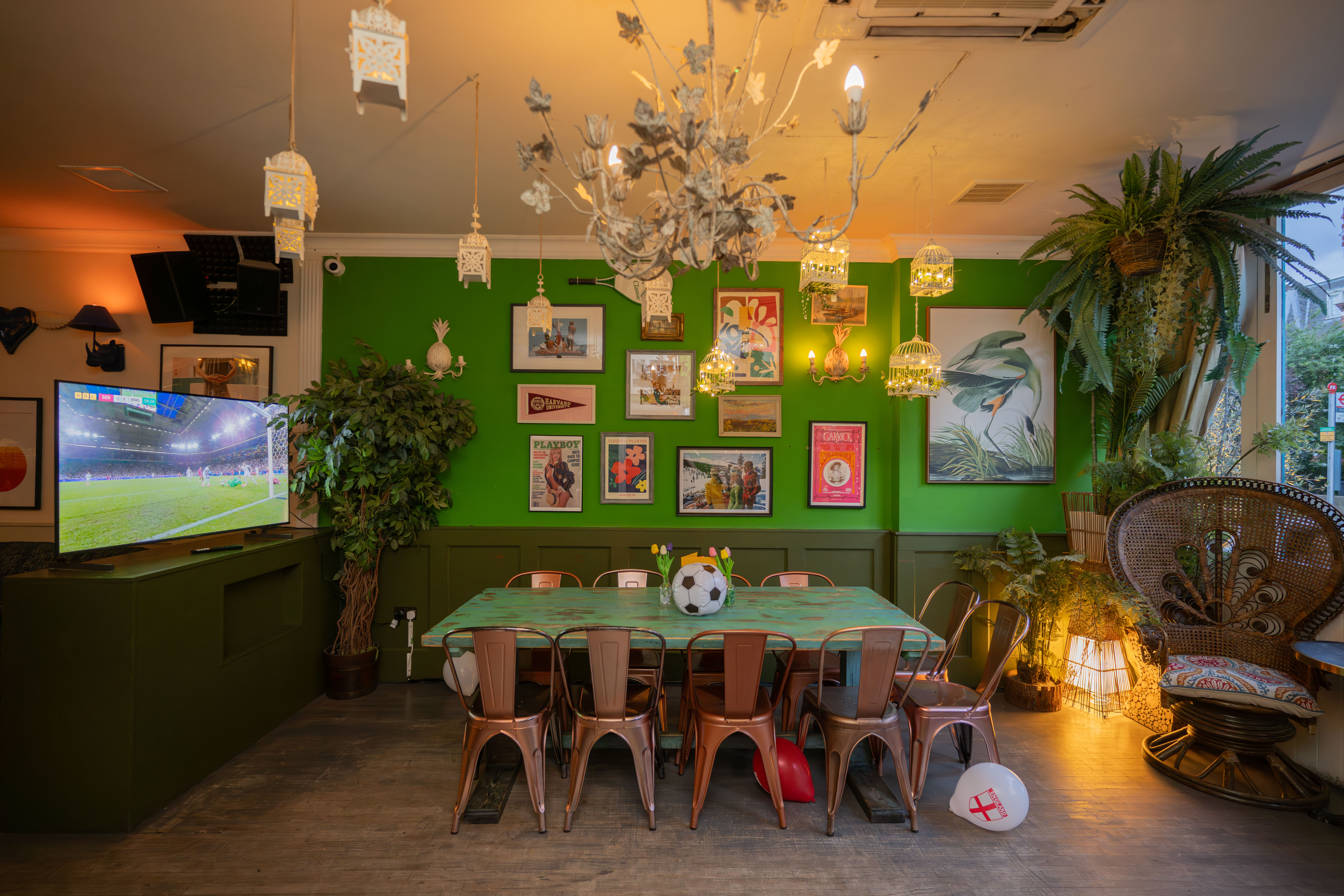 Vibrant event space with green walls, ideal for casual gatherings and meetings.