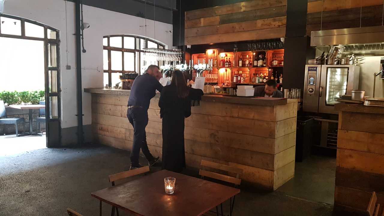 Cozy bar venue in Bermondsey for networking events with warm wooden decor.