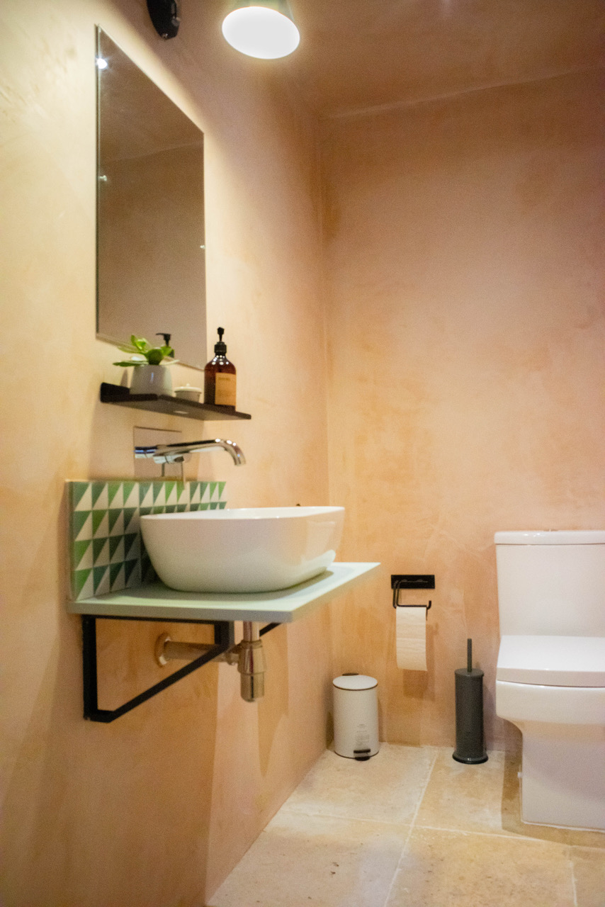 Modern restroom in The Laboratory Studio with geometric backsplash for events.