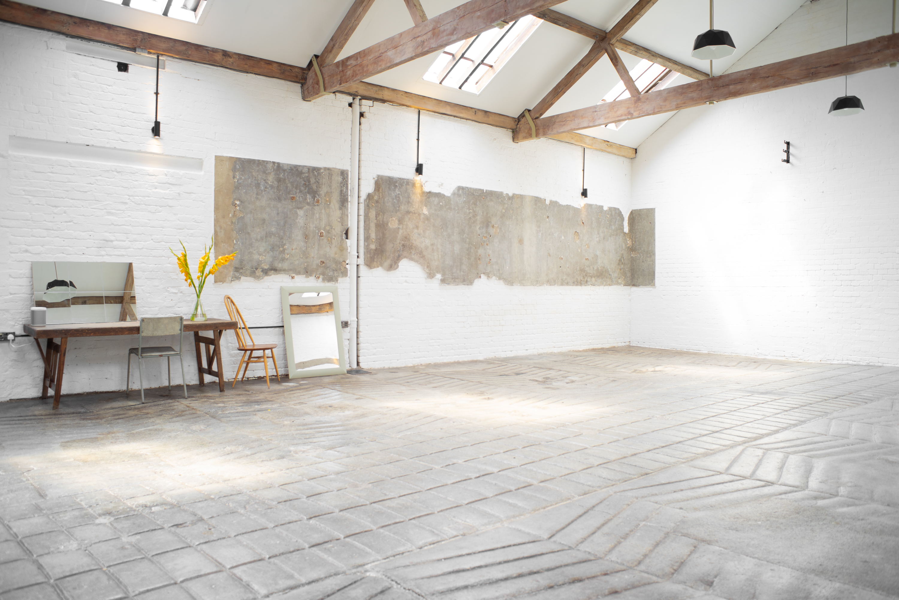 Versatile event space with exposed beams, ideal for meetings and workshops.