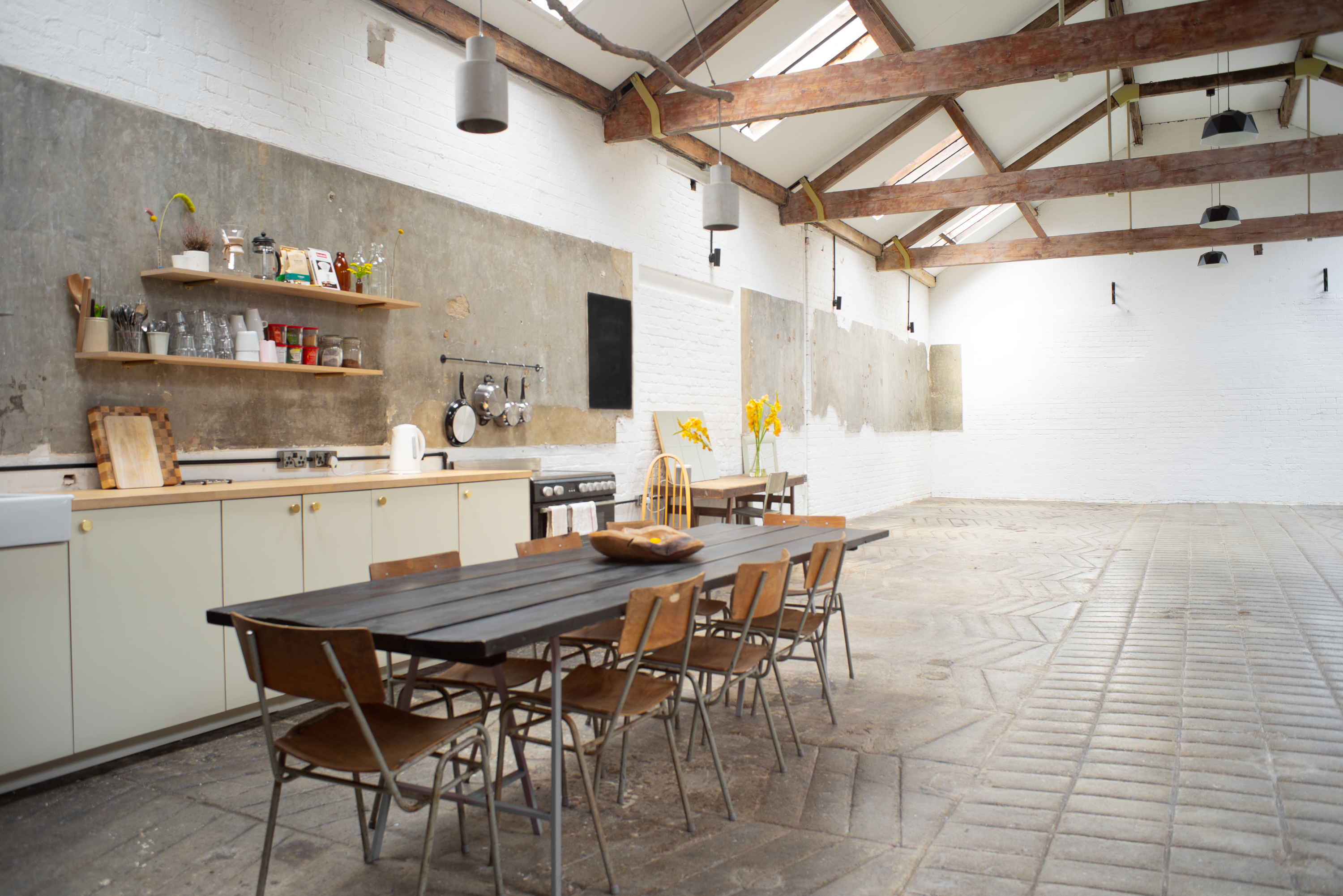 Versatile event space with modern industrial design, ideal for workshops and meetings.