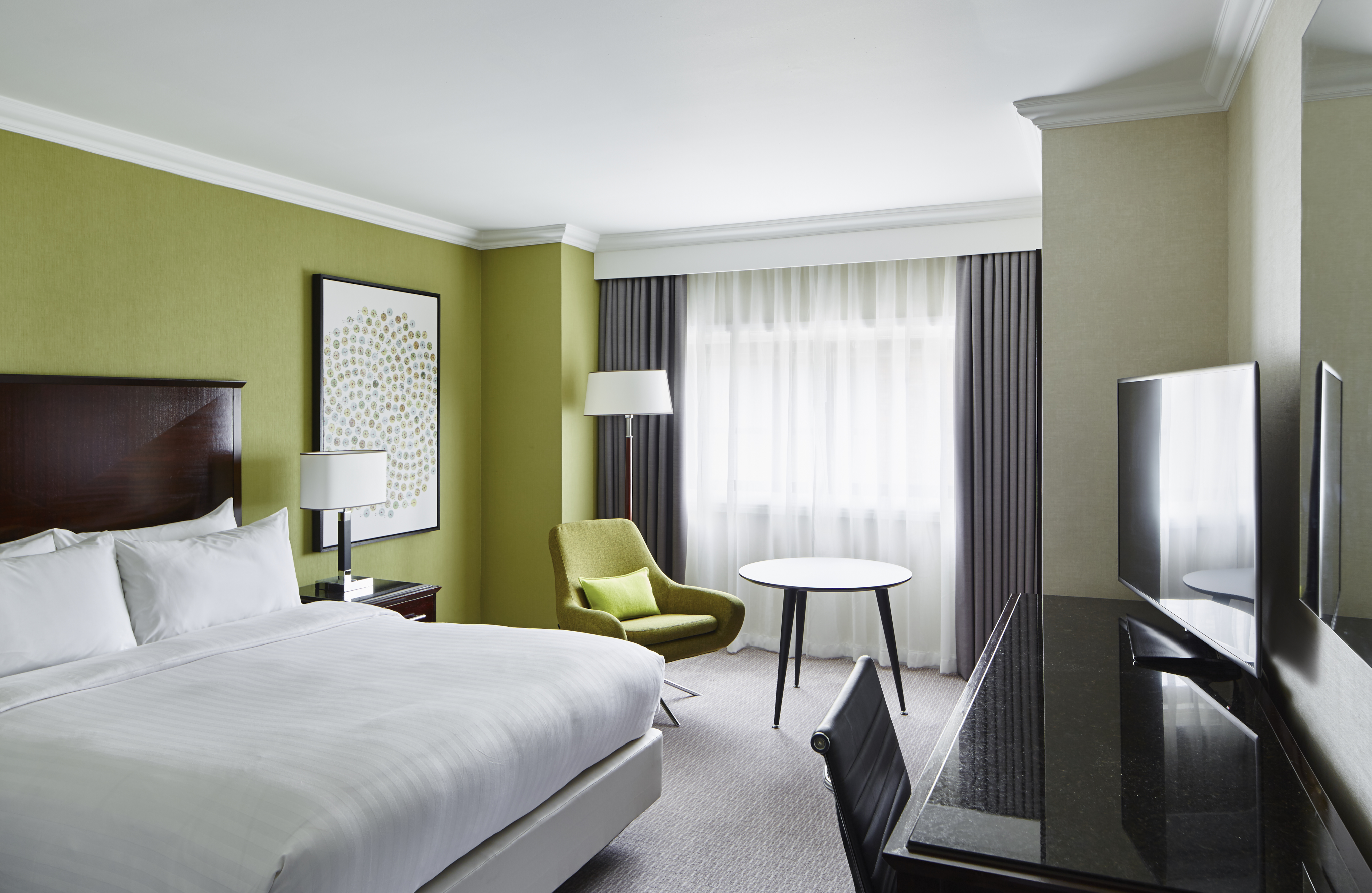 Rosewood Room at Delta Hotels: modern hotel room with green walls for business events.