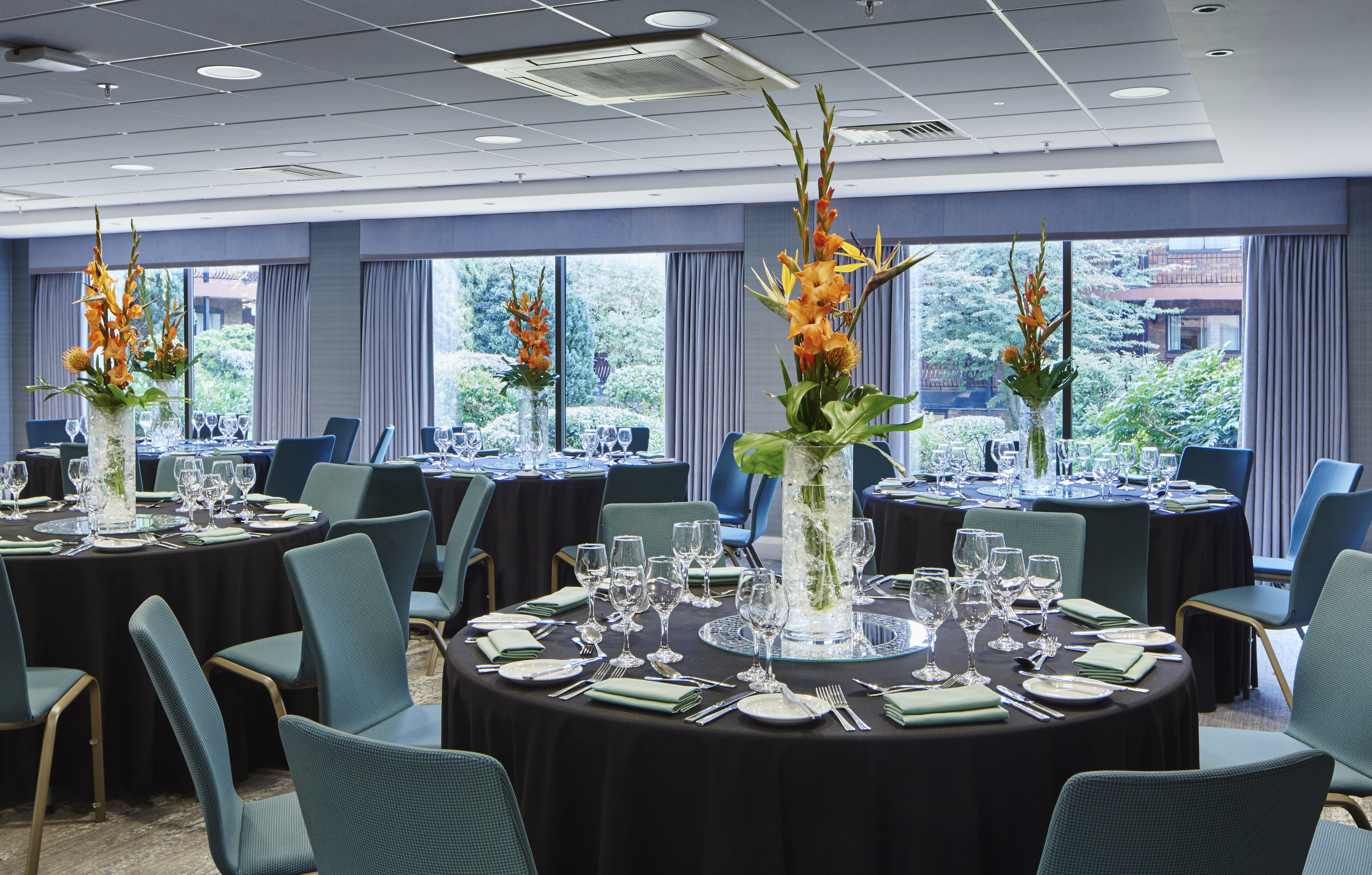 Rosewood Room at Delta Hotels: elegant event space with floral centerpieces for corporate meetings.