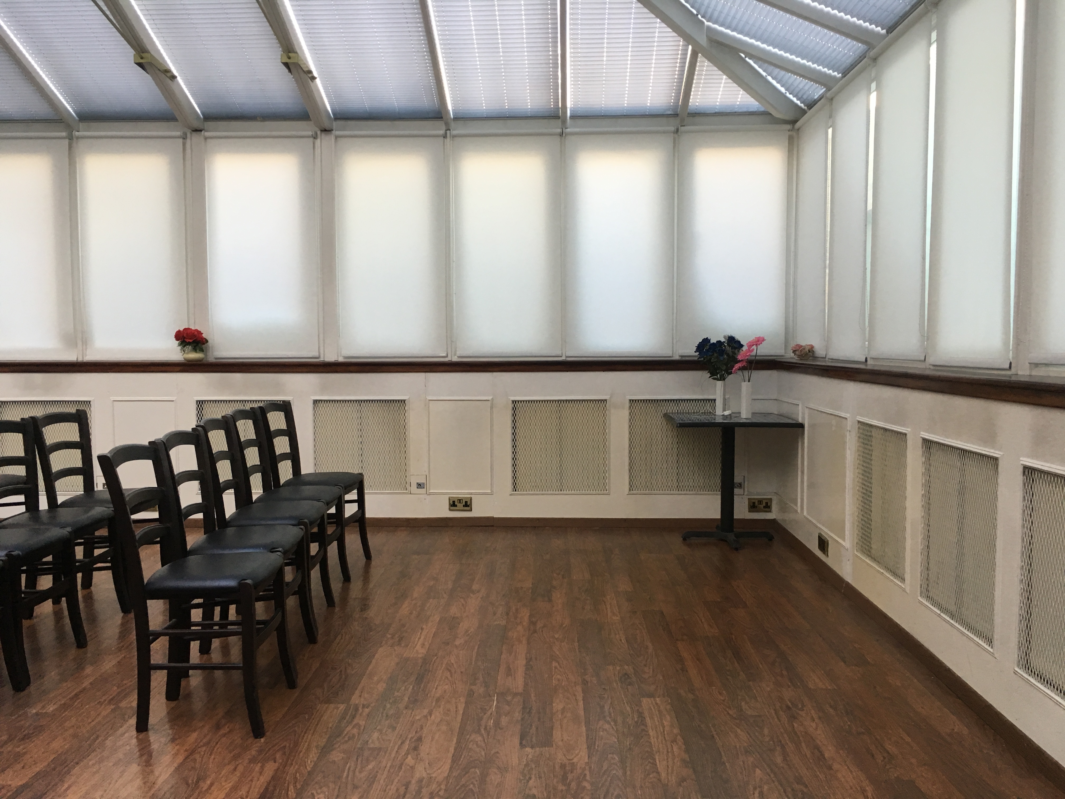 Bright meeting room with black chairs, perfect for workshops and presentations.