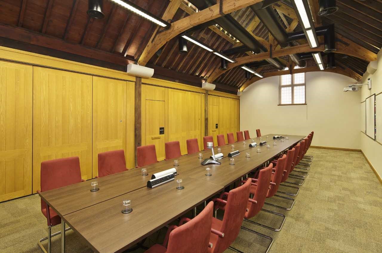 Mansion House meeting room with red chairs, ideal for corporate meetings and workshops.