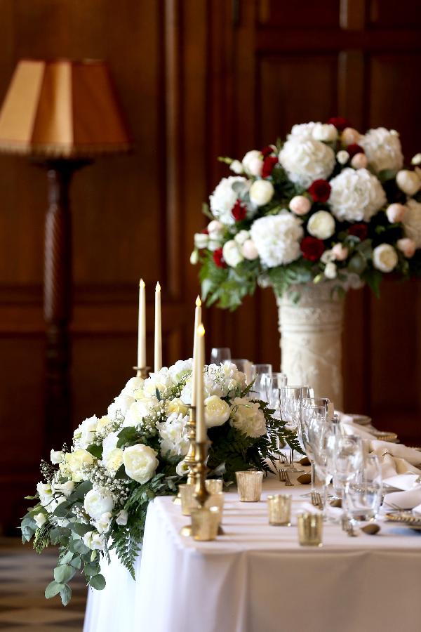 Elegant table setting with floral arrangements at The Mansion House for weddings.