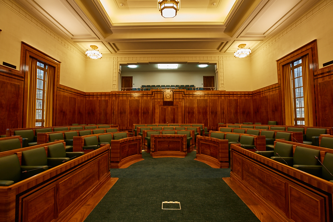 Council Chamber at Hackney Town Hall with wooden paneling, ideal for formal meetings.